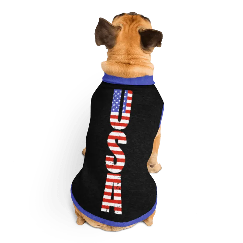 Dog wearing a black shirt with 'USA' printed in American flag colors on a white background