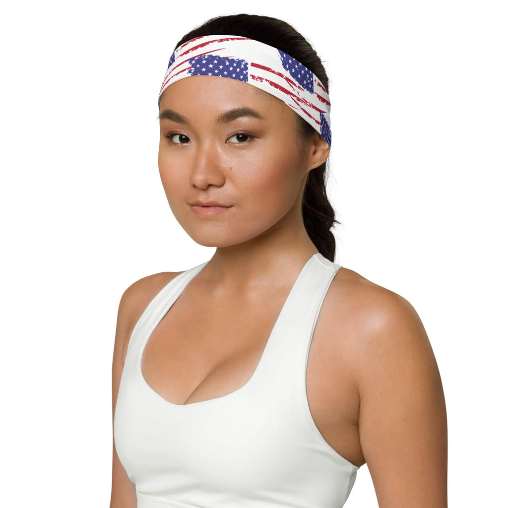 Woman wearing a white tank top and an American flag headband on a white background