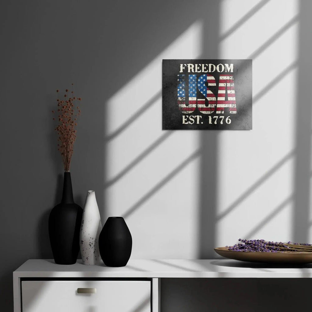 Patriotic metal sign hang on a wall with the American flag in the shape of USA and the text " Freedom Est. 1776" 