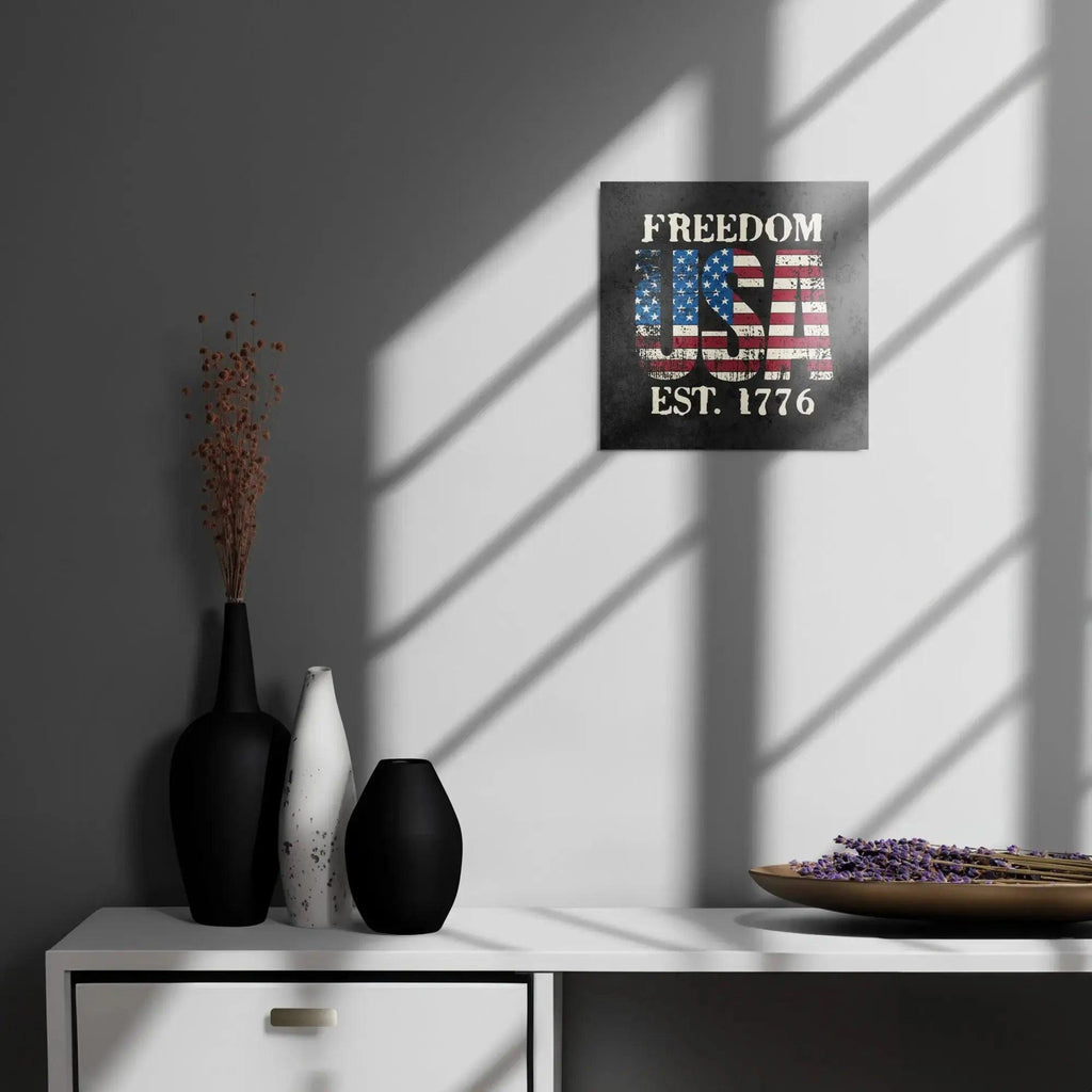 Patriotic metal sign hang on a wall with the American flag in the shape of USA and the text " Freedom Est. 1776" 