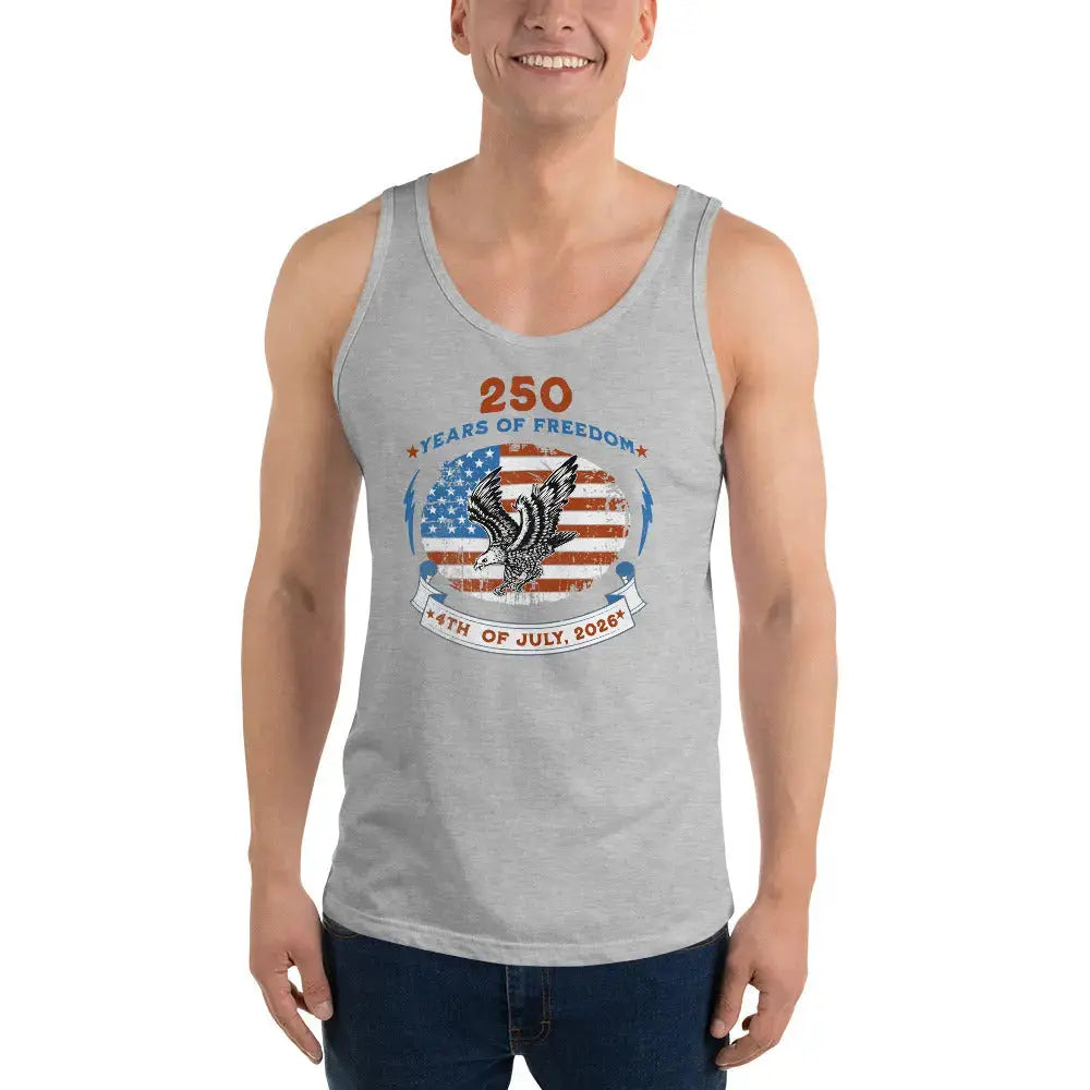A man wearing a athletic heather patriotic tank top with a flying eagle over the American flag and the text "250 years of freedom, 4th of July, 2026."