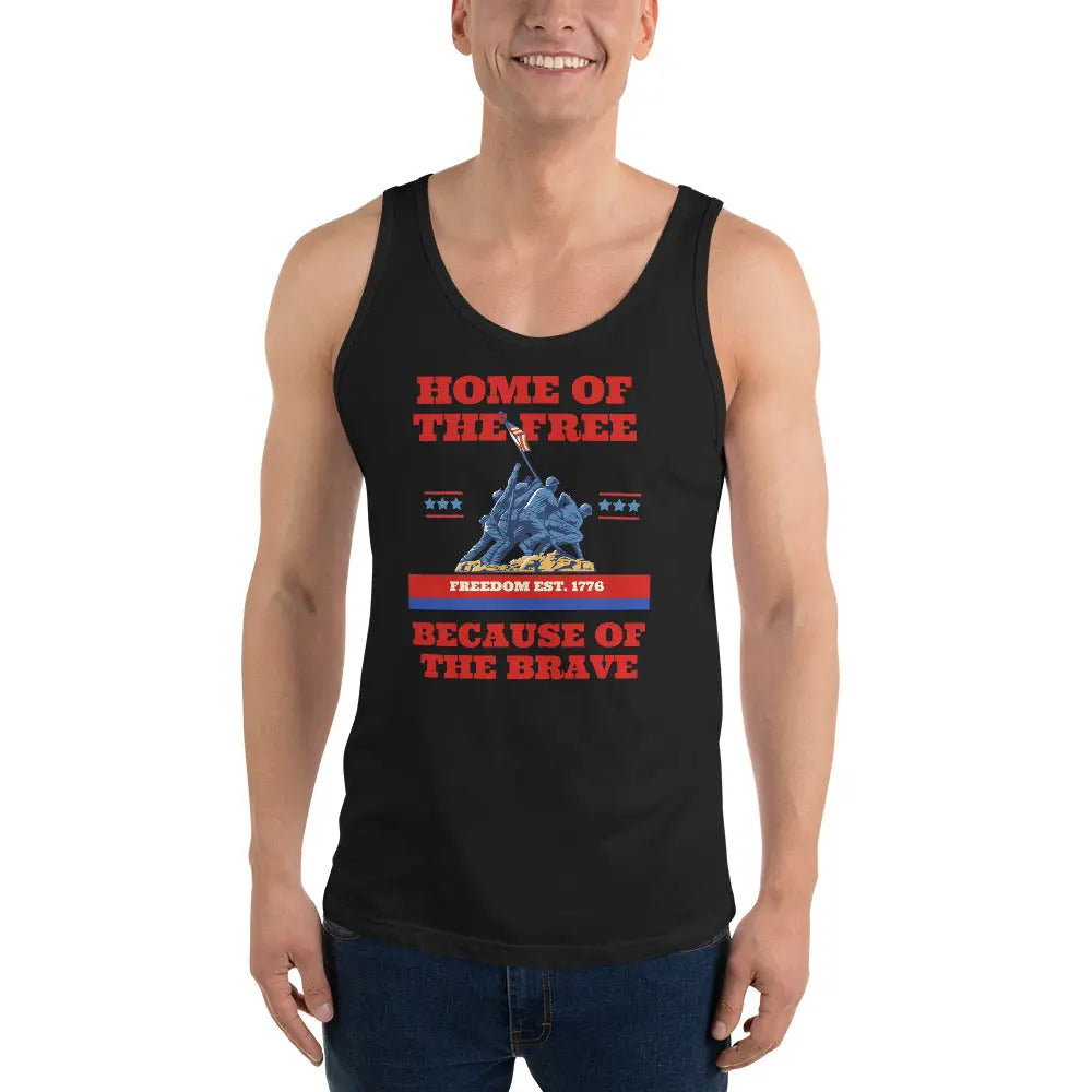 A man wearing a black patriotic tank top with soldiers raising the American flag with the text "Home Of The Free Because Of The Brave."