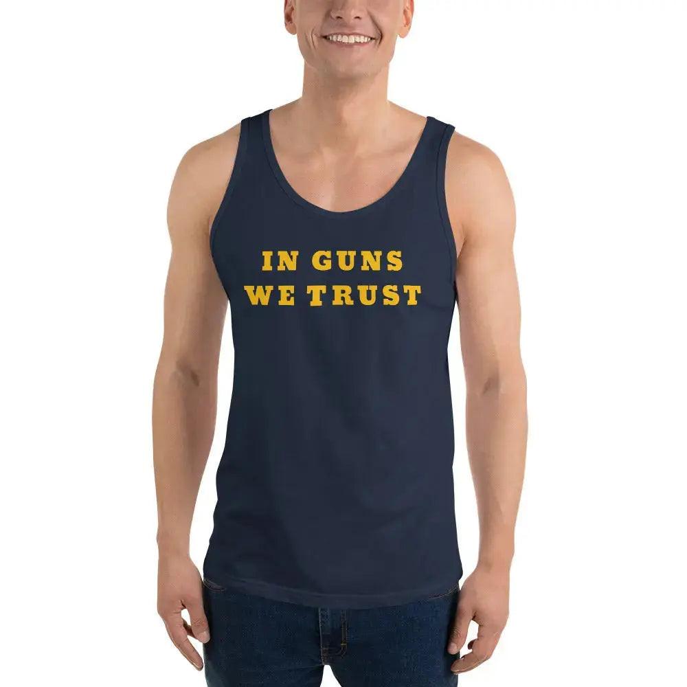 A man wearing a navy patriotic tank top with the text "In Guns We Trust." 
