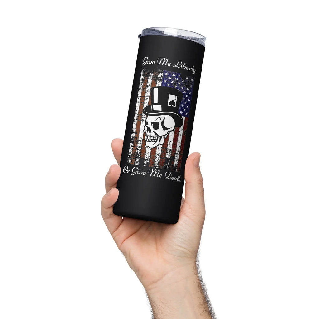 A hand holding a black patriotic stainless steel tumbler with an American flag and skull design and the text "Give me liberty or give me death."