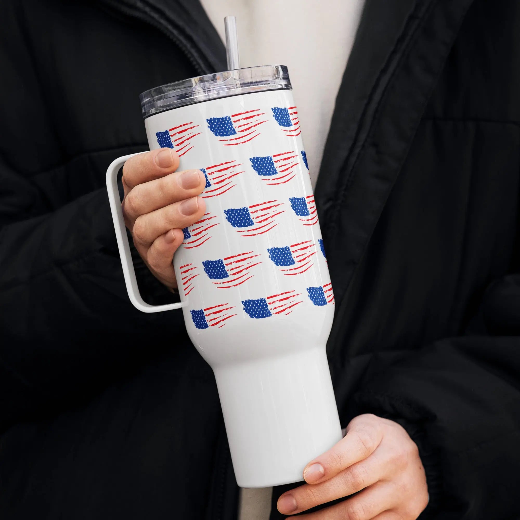Person holding a white tumbler with American flag pattern