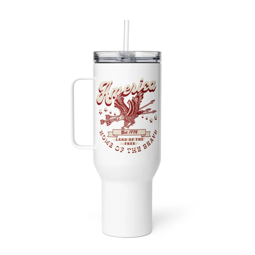 A white travel tumbler with a flying eagle and the text 'America Home Of The Brave' in red and white.
