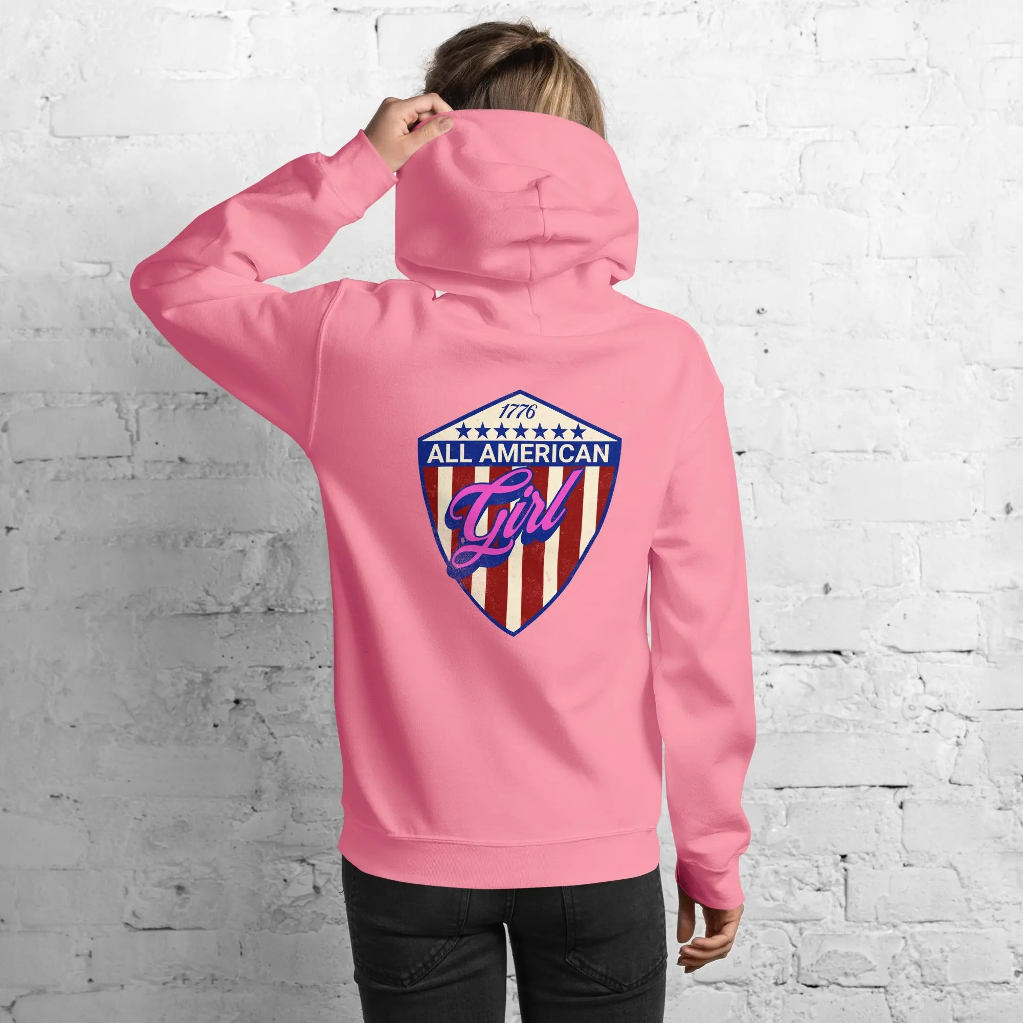 Back of a woman wearing a patriotic azalea hoodie with the text "All American Girl" over a patriotic design. 
