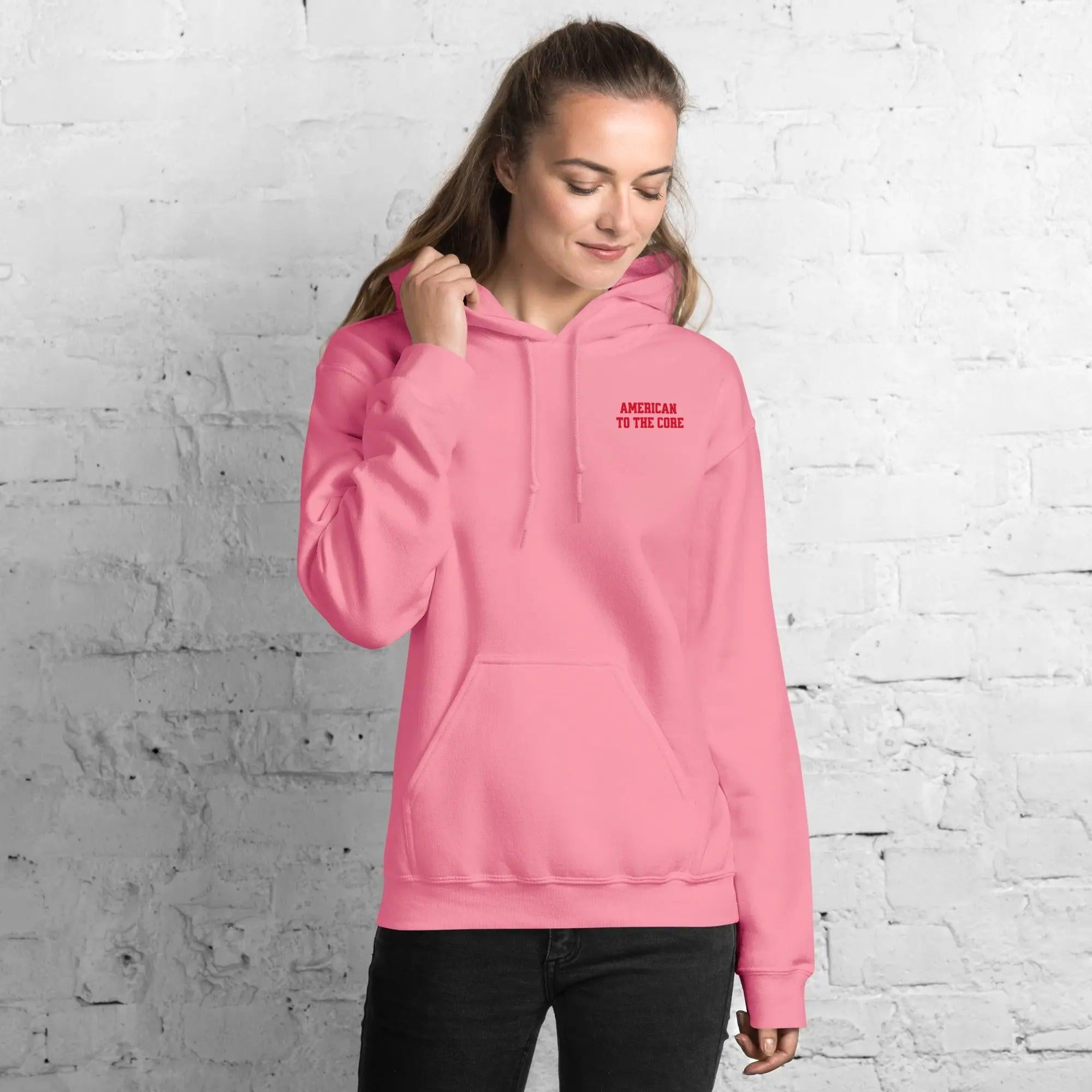 A woman wearing a azalea hoodie with the text "American to the core"