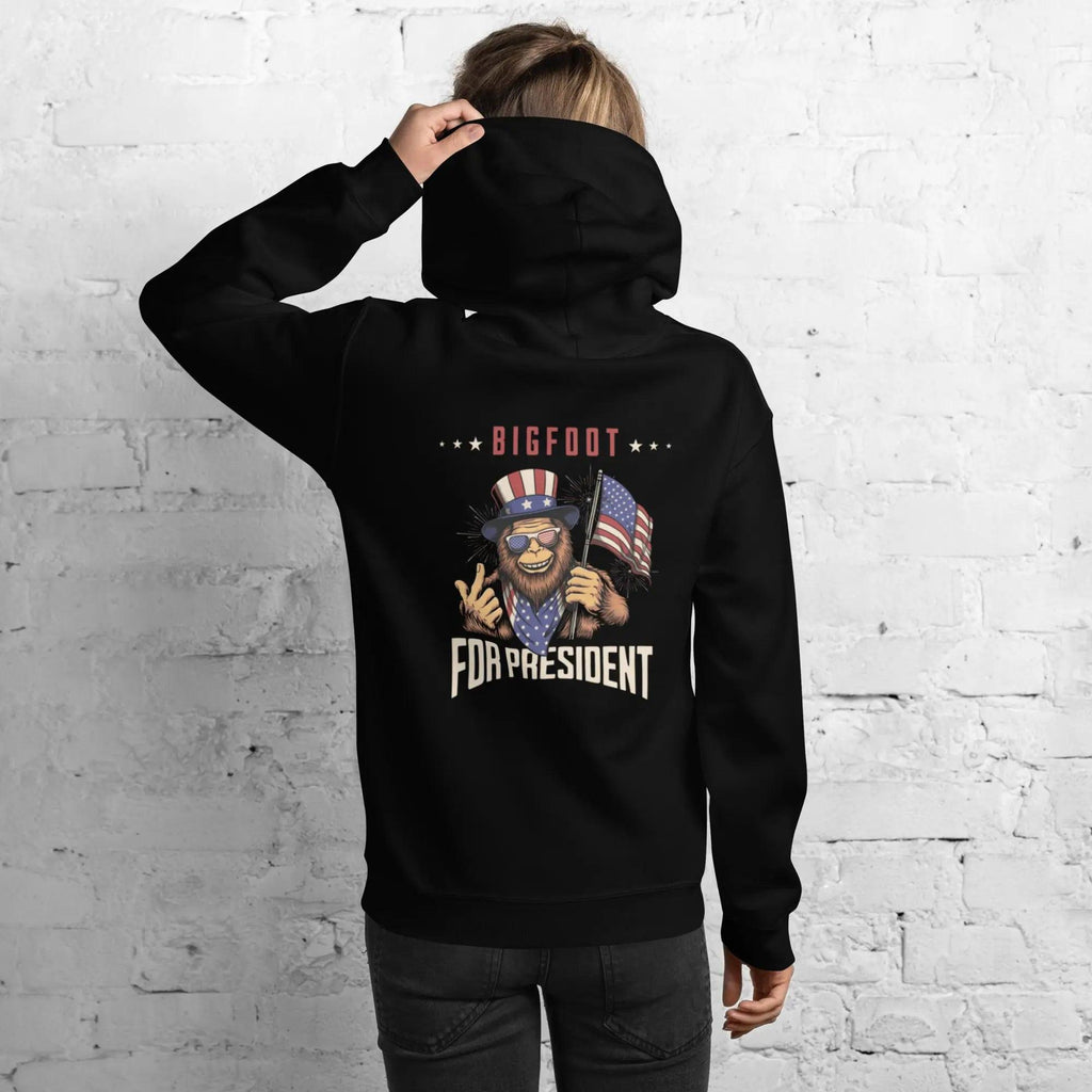 Back of a woman wearing a black, patriotic hoodie with Bigfoot and the text "Bigfoot for President."