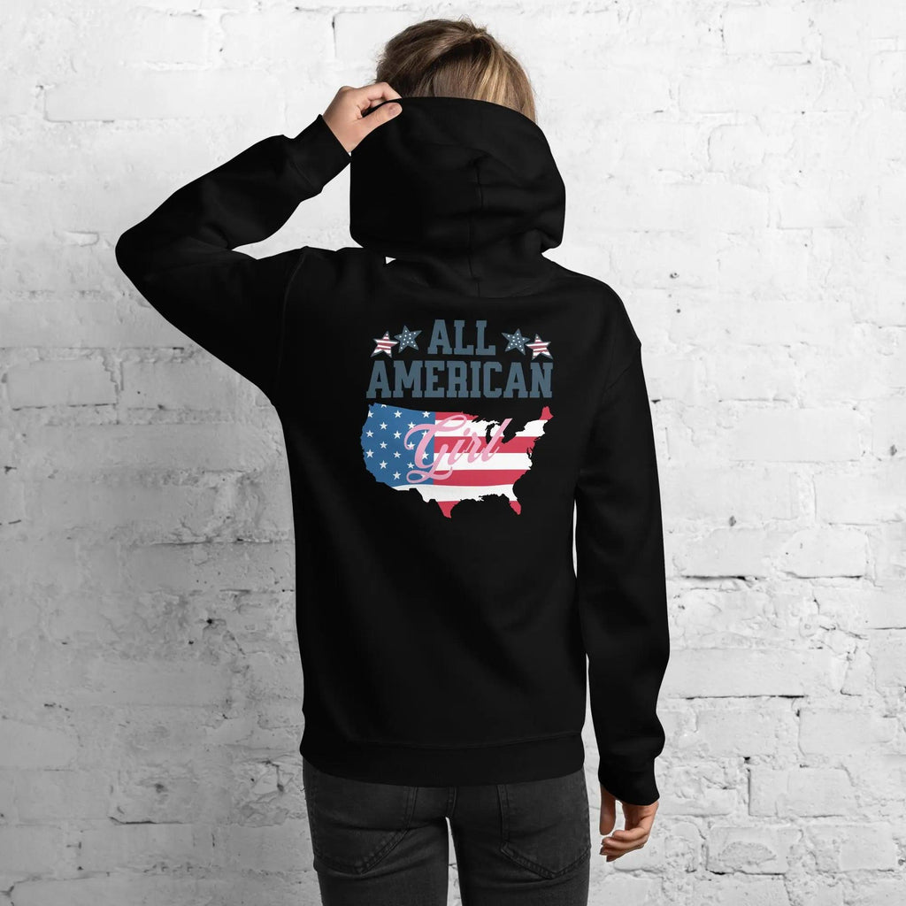 The back of a woman wearing a black patriotic hoodie with the silhouette of America with the flag in it and the text "All American Girl."