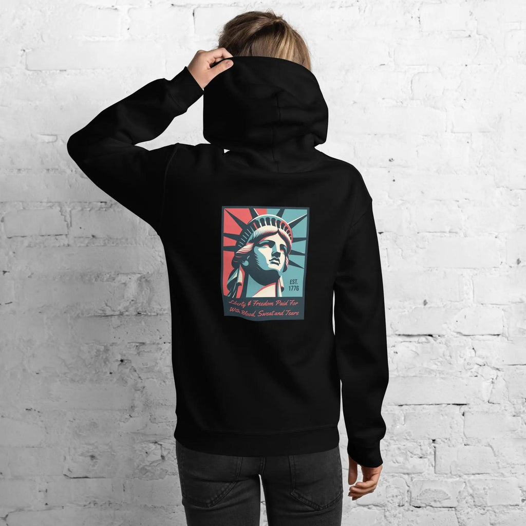 The back of a woman wearing a black patriotic hoodie with the Statue of Liberty and text. 