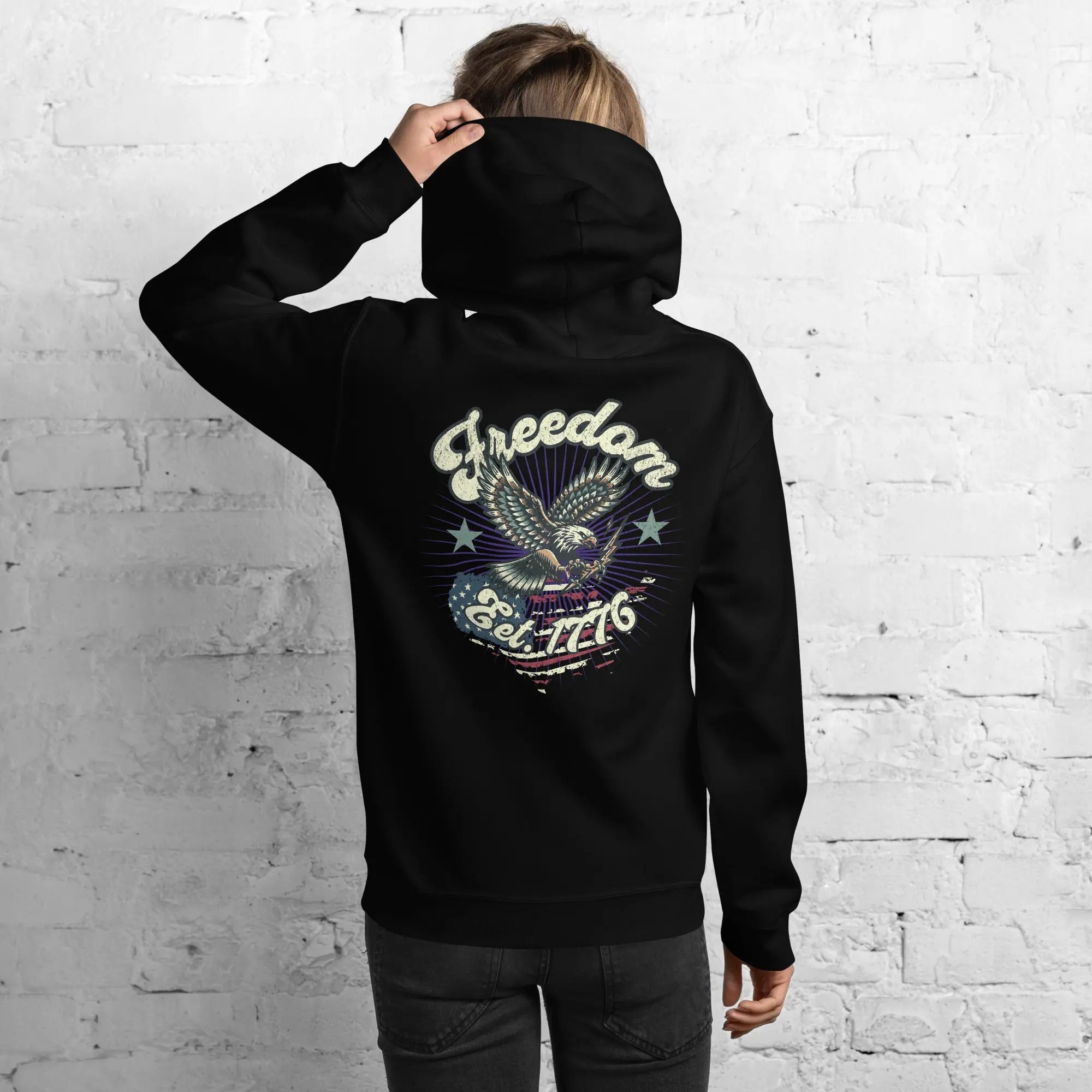 Back of woman wearing a black patriotic hoodie with an eagle and the text "Freedom Est. 1776" 