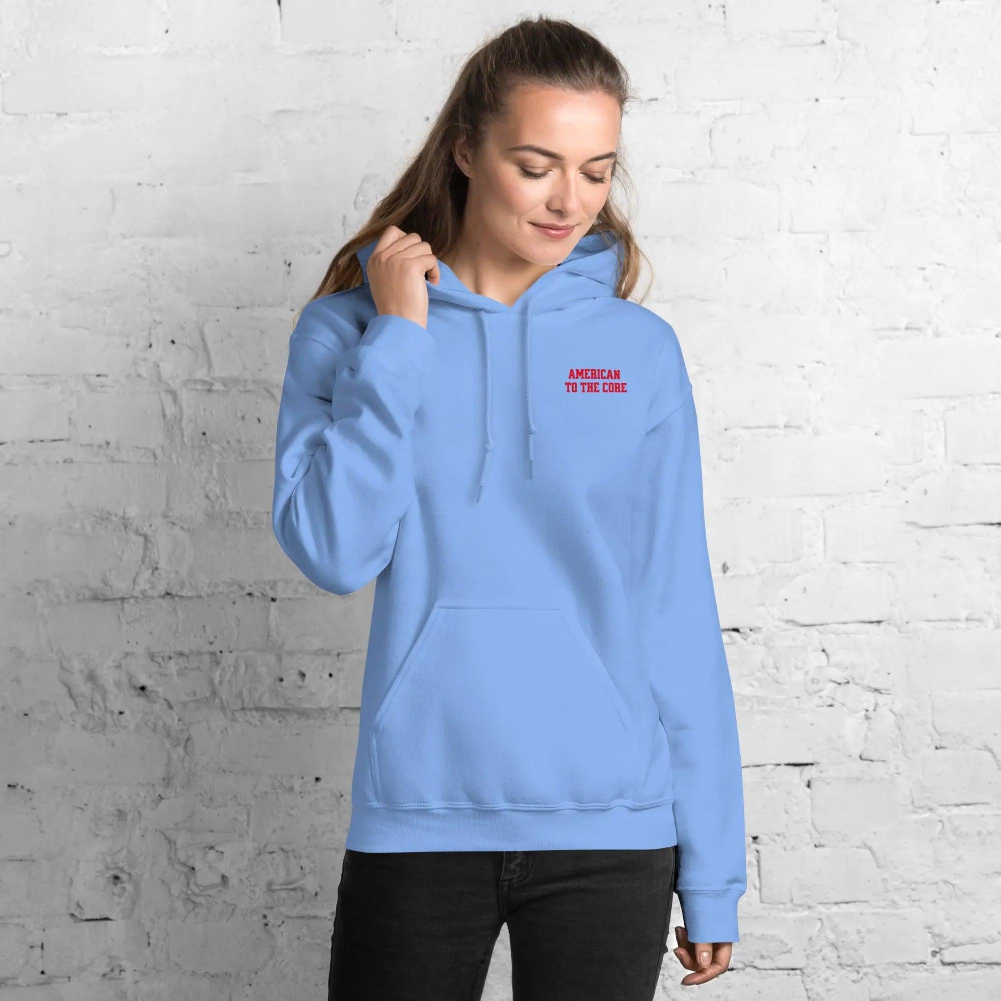 A woman wearing a carolina hoodie with the text "American to the core"
