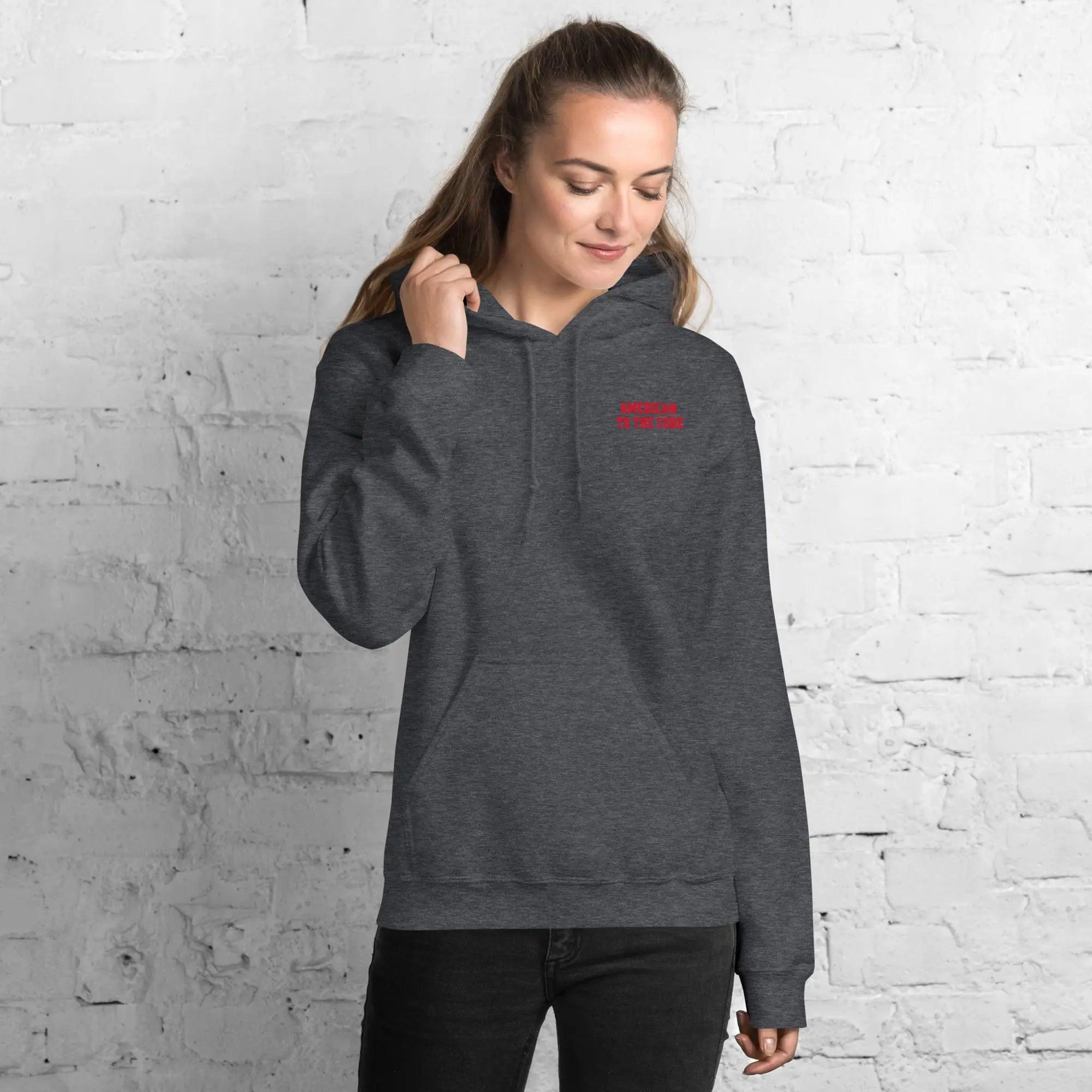 A woman wearing a dark heather hoodie with the text "American to the core"