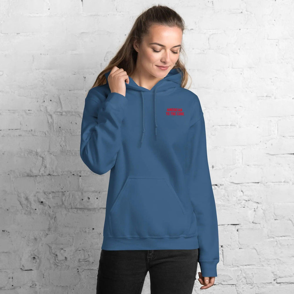 A woman wearing a indigo blue hoodie with the text "American to the core"