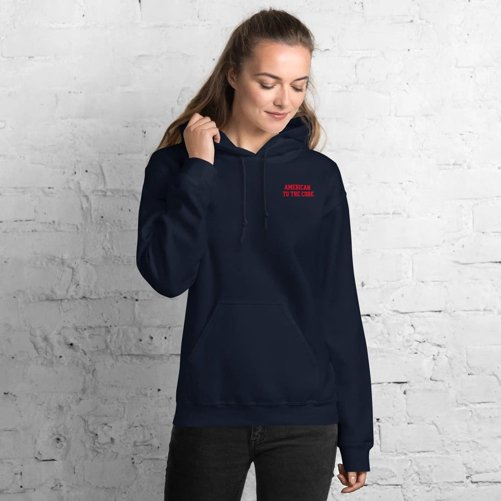 A woman wearing a navy hoodie with the text "American to the core"