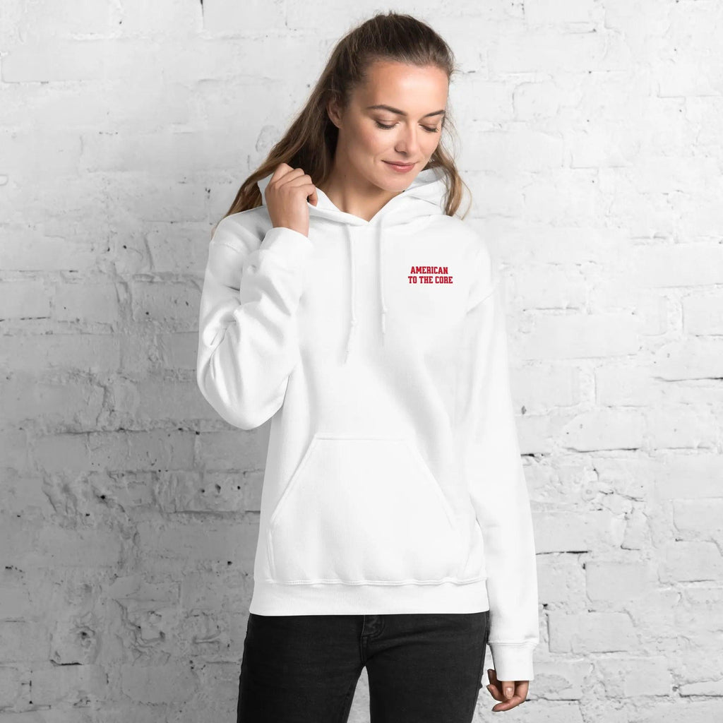 A woman wearing a white hoodie with the text "American to the core"