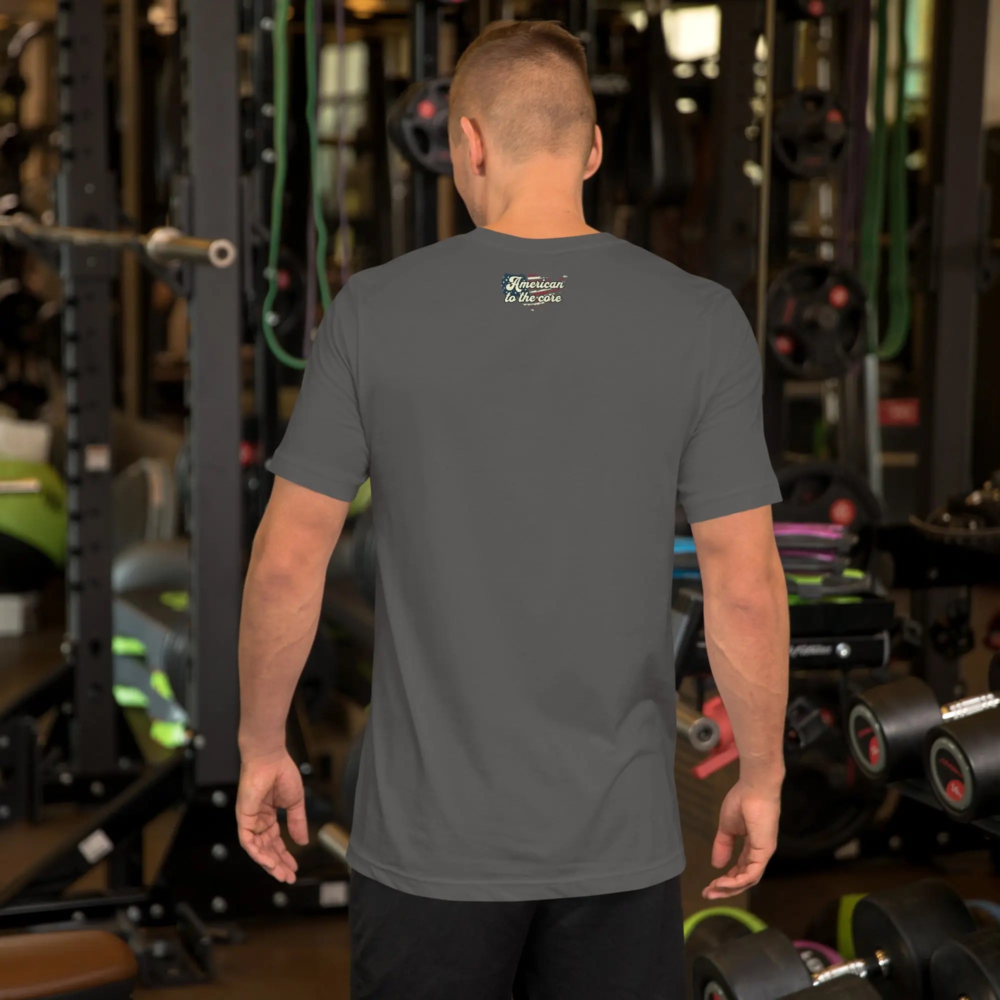 Back of man wearing an asphalt coloered patriotic t-shirt with "America to the core" text