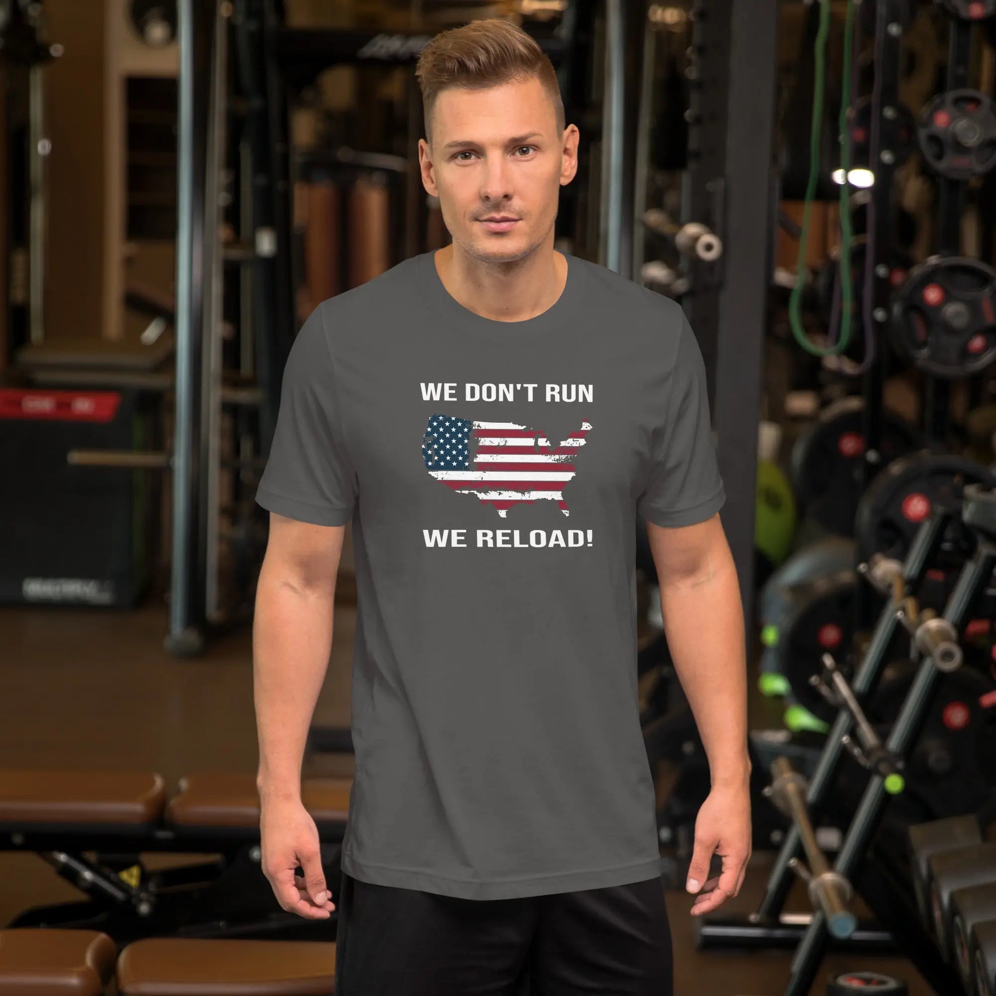 man wearing a gray patriotic t-shirt with "We don't run, we reload" text.