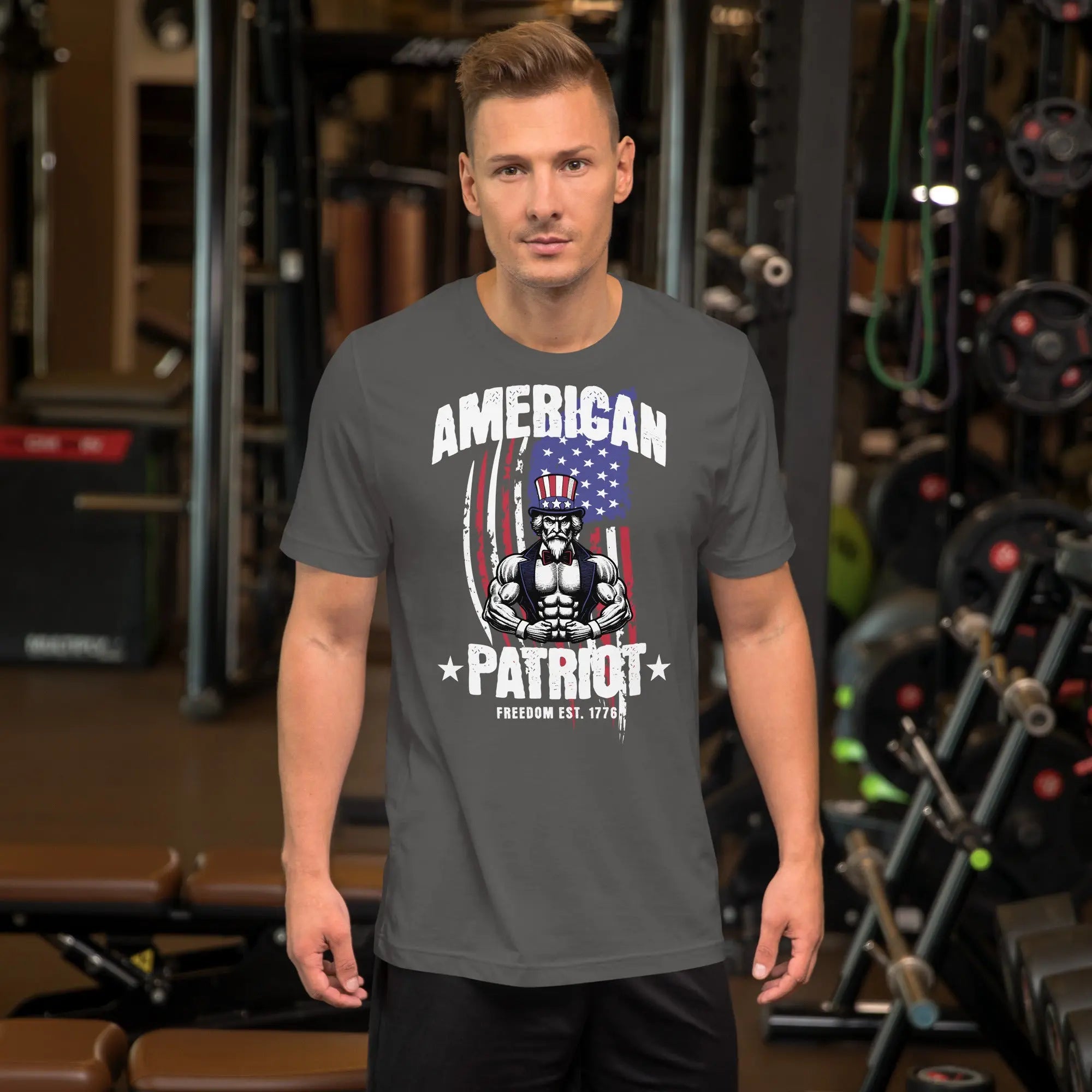 A man wearing an asphalt-colored patriotic t-shirt with a muscular Uncle Sam with "American Patriot" text.