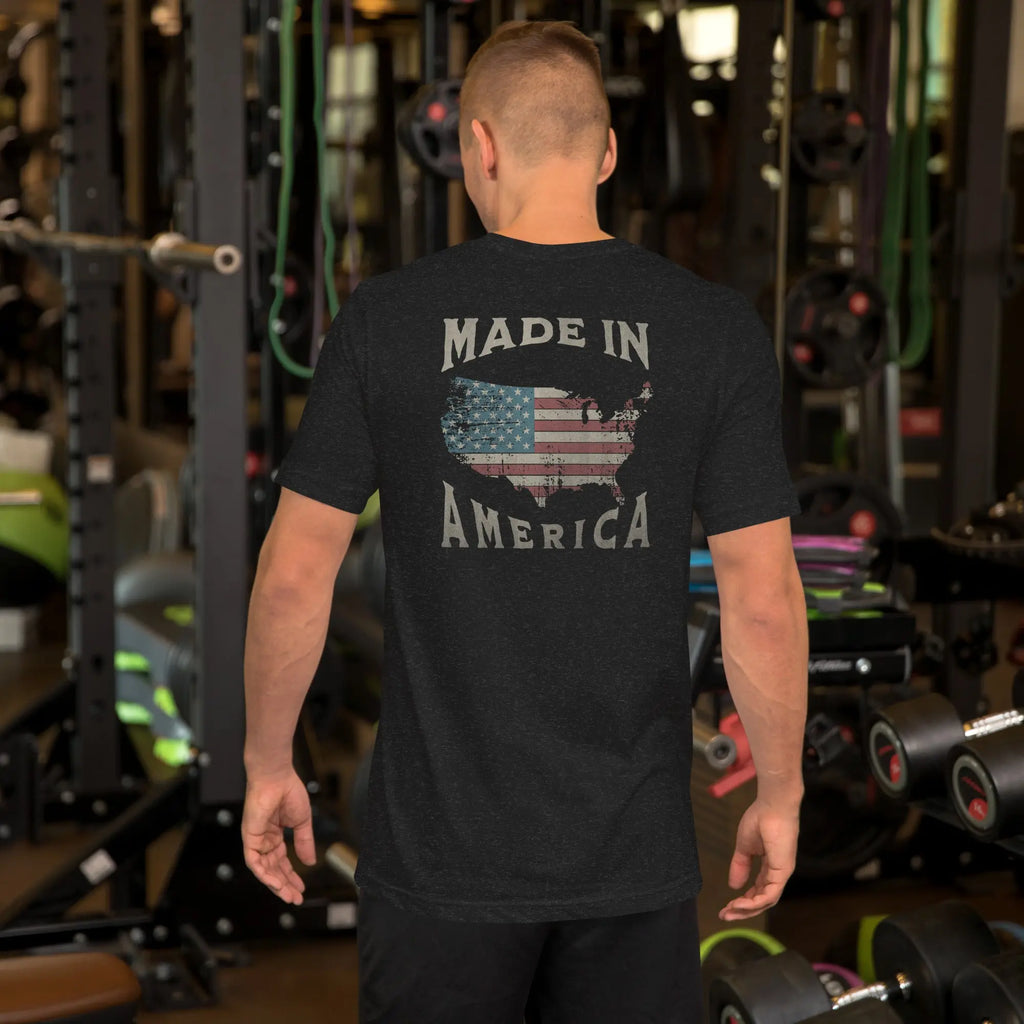 man wearing a black patriotic t-shirt with "made in america" text. A silhouette of america with the american flag in it. 