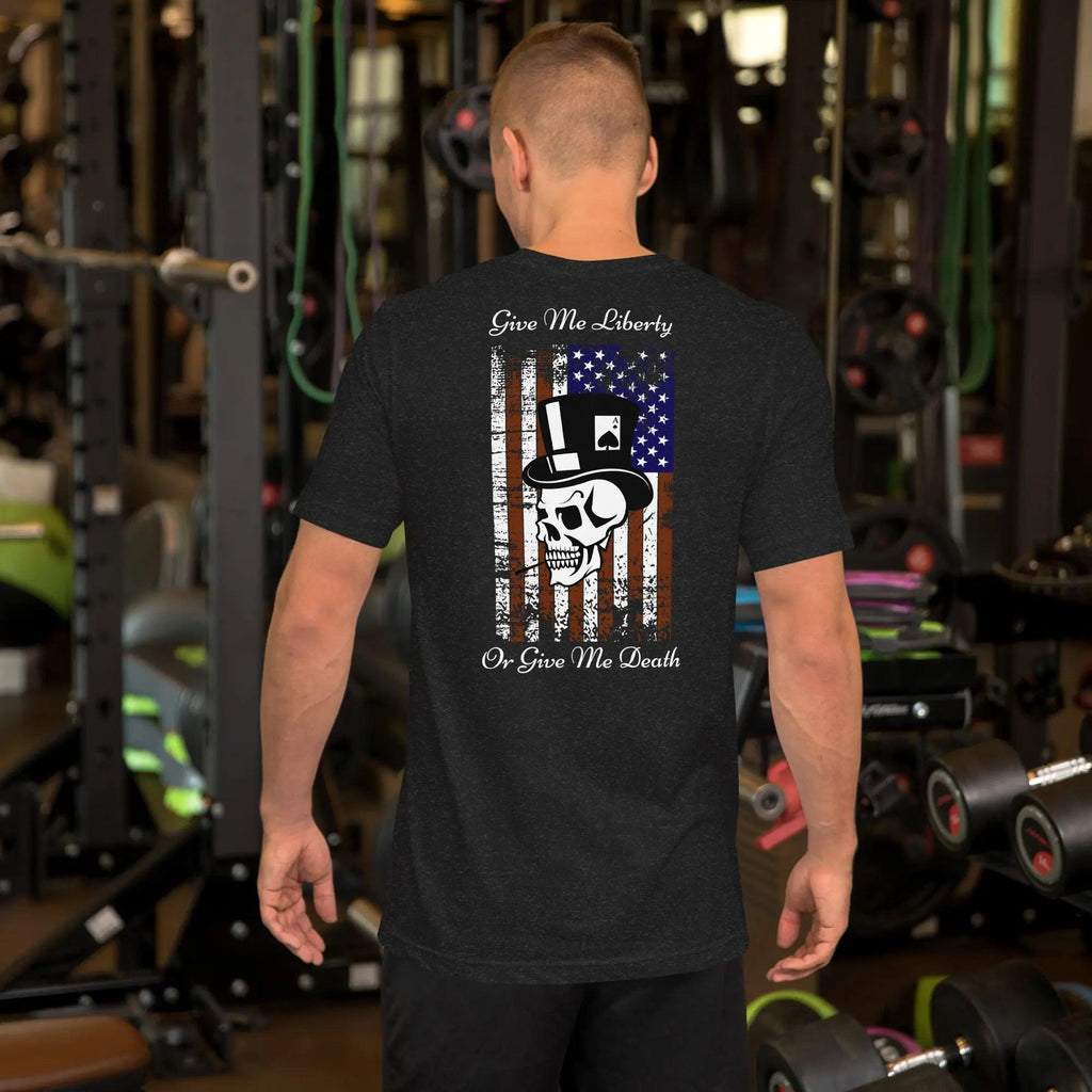 The back of a man wearing a black heather patriotic T-shirt with a skull over the American flag and the text "Give Me Liberty or Give Me Death."