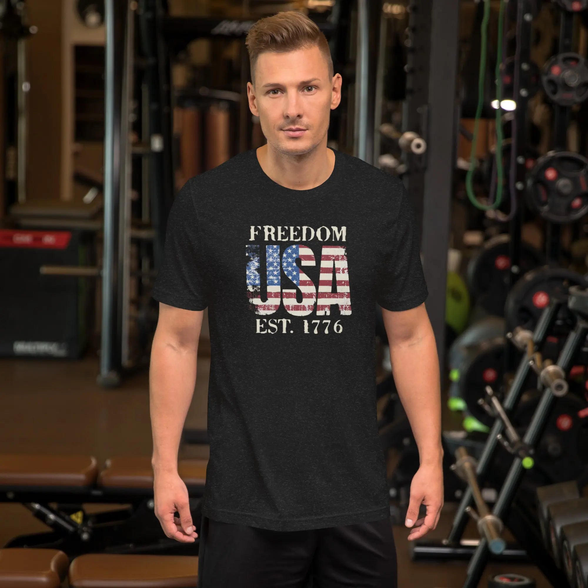 a man wearing a black patriotic t-shirt with "Freedom USA Est. 1776" text.