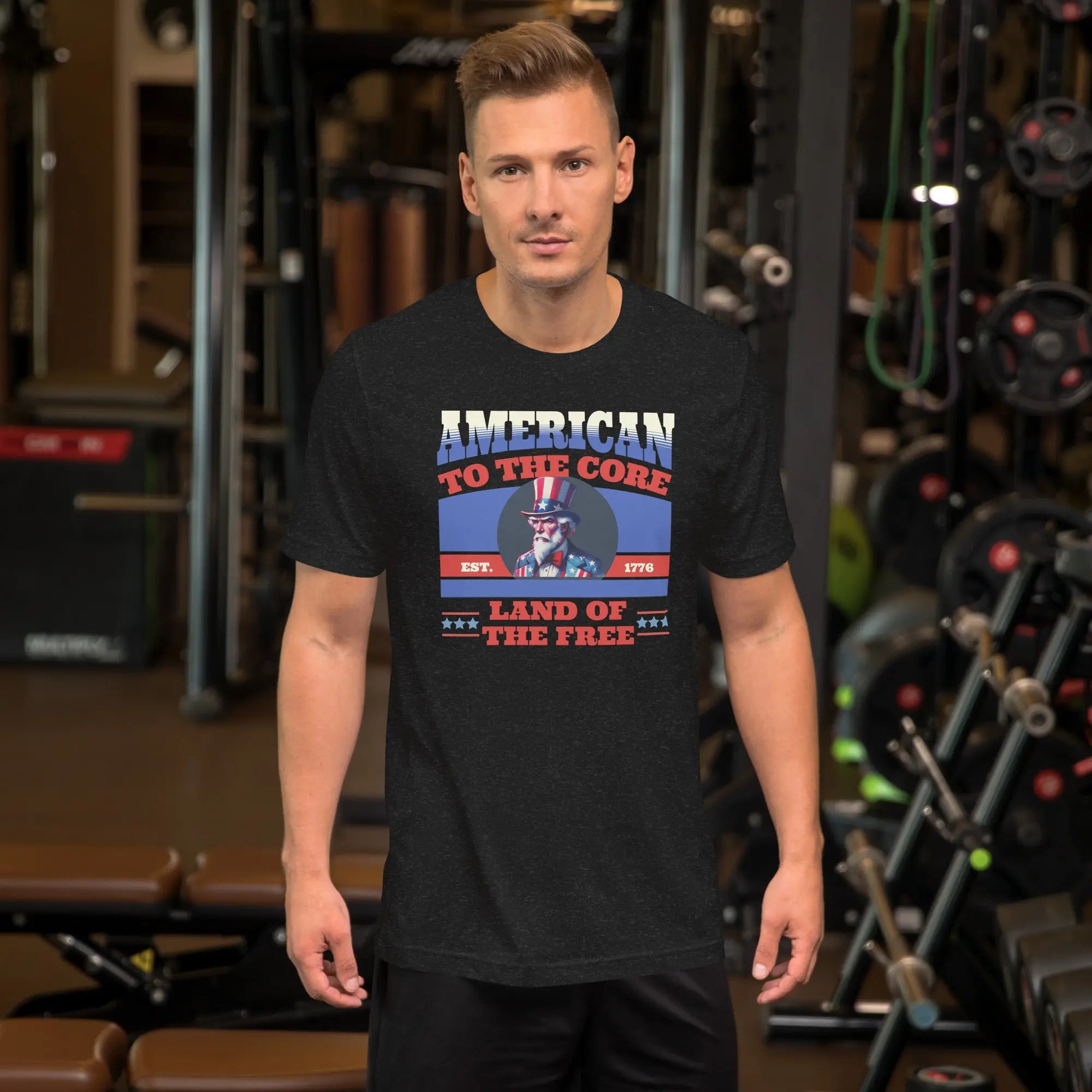 A man wearing a black heather patriotic t-shirt with an image of Uncle Sam and "Land of the Free" text.
