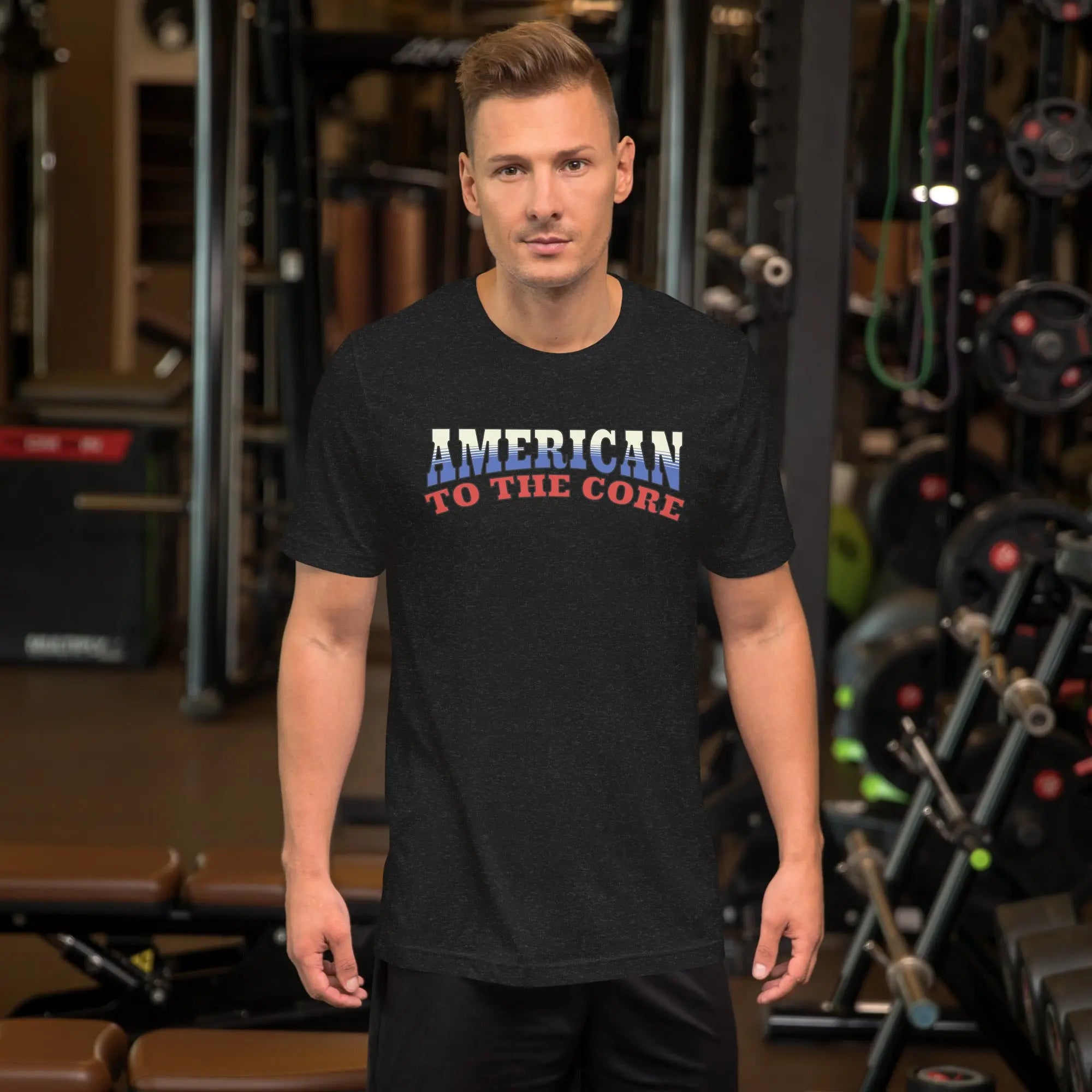 A man wearing a black heather patriotic t-shirt with "America to the core" text in red, white and blue