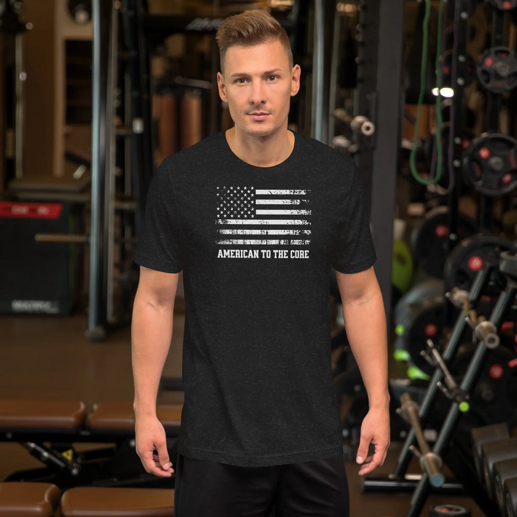 A man wearing a black heather patriotic t-shirt with an American flag and "American to the core" text.