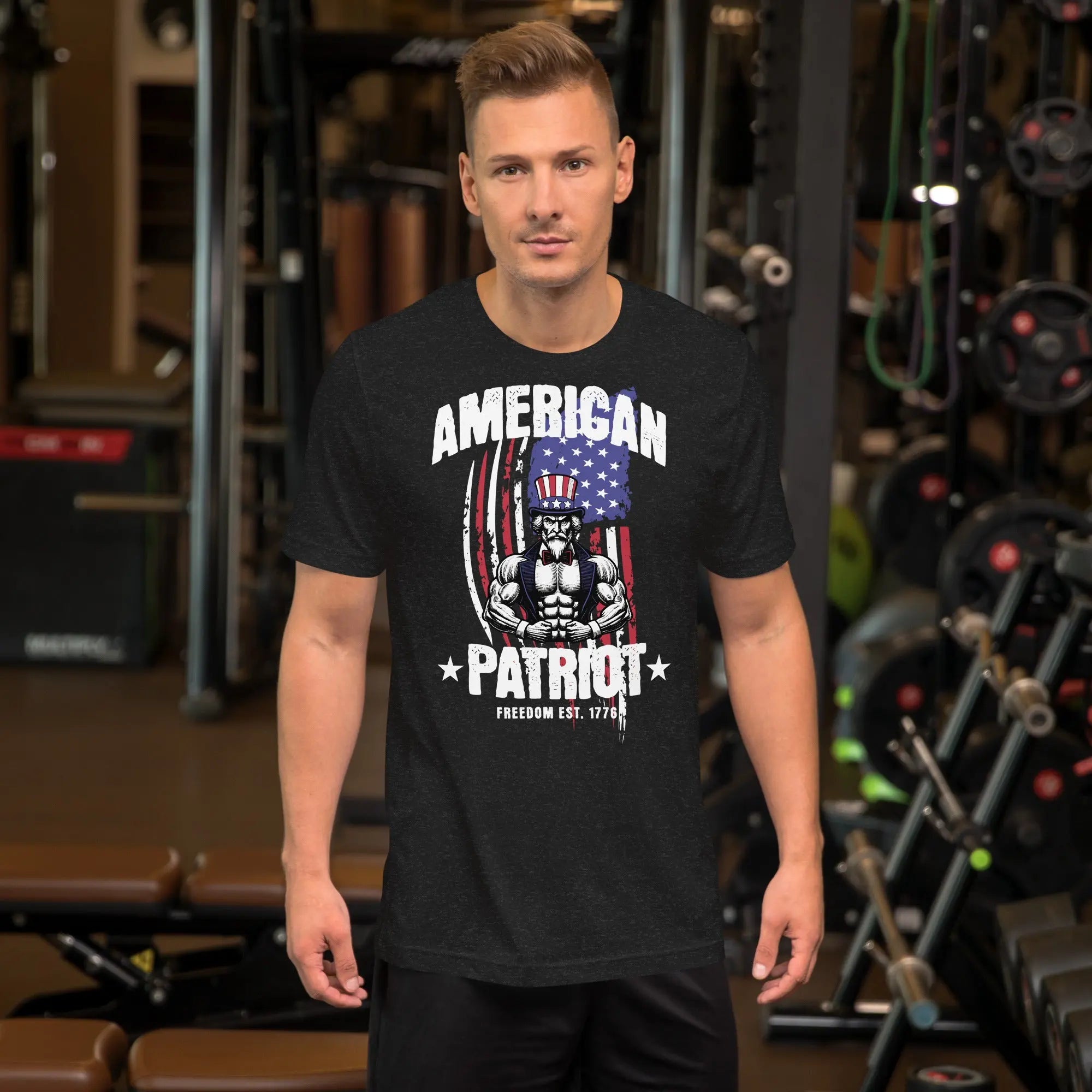 A man wearing a black heather patriotic t-shirt with a muscular Uncle Sam with "American Patriot" text.