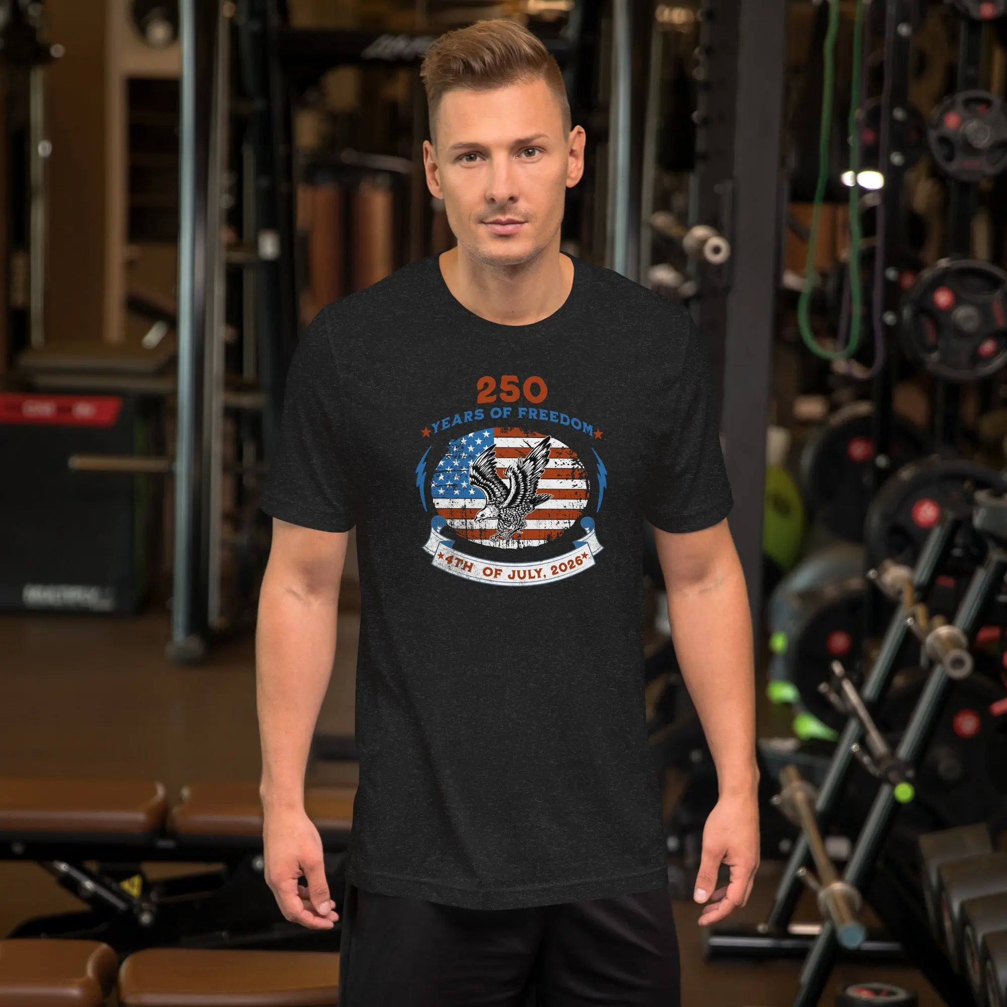 A man wearing a black heather patriotic men's t-shirt with an eagle over the American flag and the text "250 years of freedom, 4th of July, 2026."