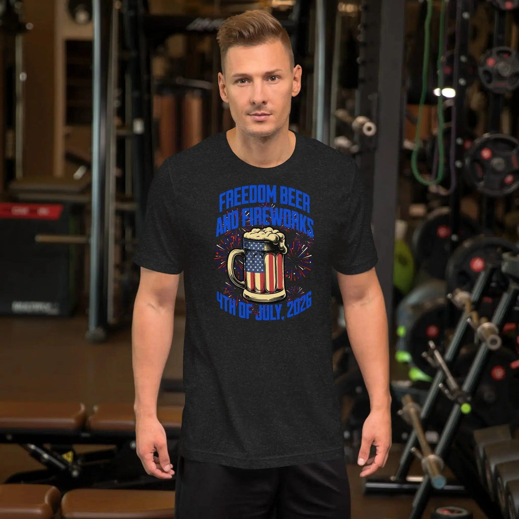 A man wearing a black heather patriotic t-shirt with a beer mug and fireworks with the text "Freedom, Beer, and Fireworks" and "4th of july, 2026."