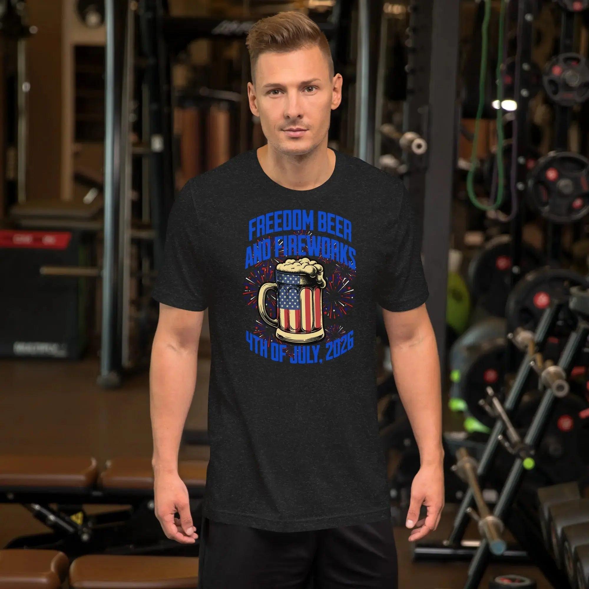 A man wearing a black heather patriotic t-shirt with a beer mug and fireworks with the text "Freedom, Beer, and Fireworks" and "4th of july, 2026."