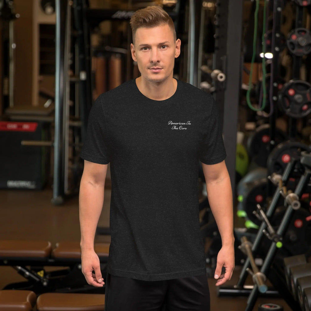 A man wearing a black heather patriotic T-shirt with the text "American to the Core." 