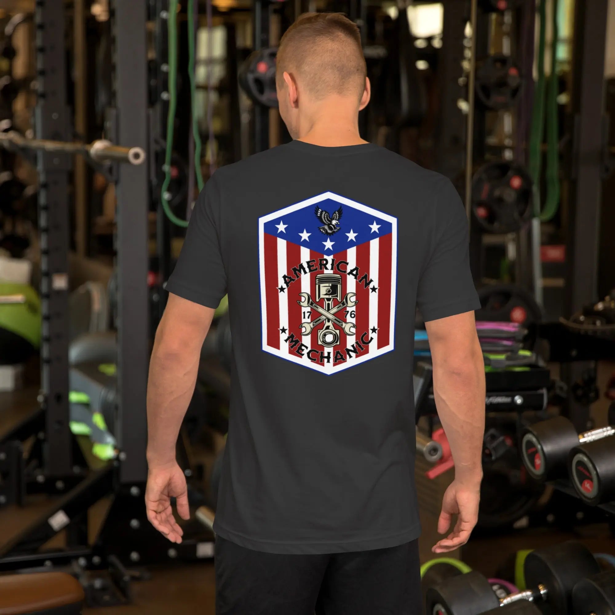 Back of man wearing a dark grey patriotic t-shirt with "American Mechanic" text