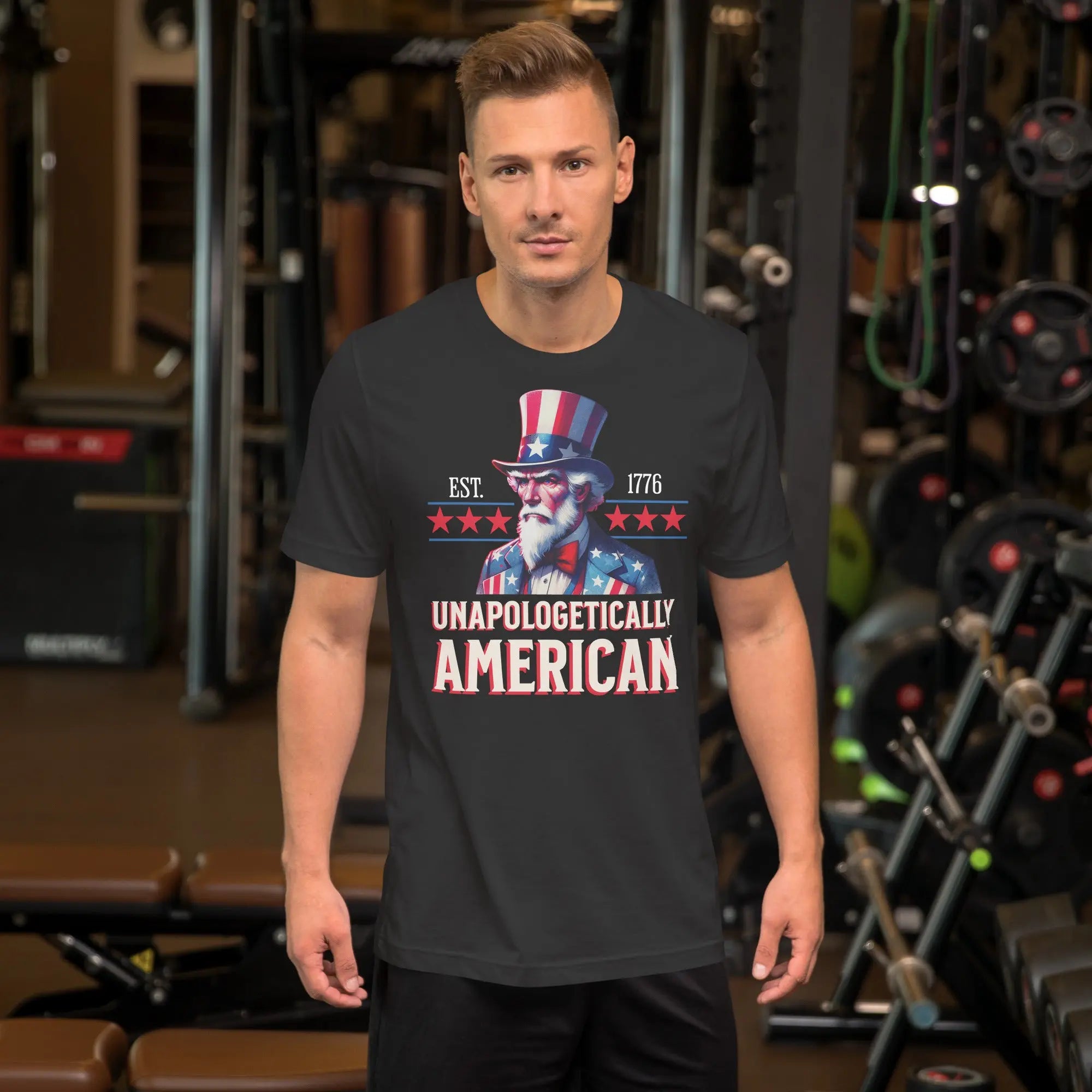 Man wearing a black t-shirt with a patriotic design in a gym setting