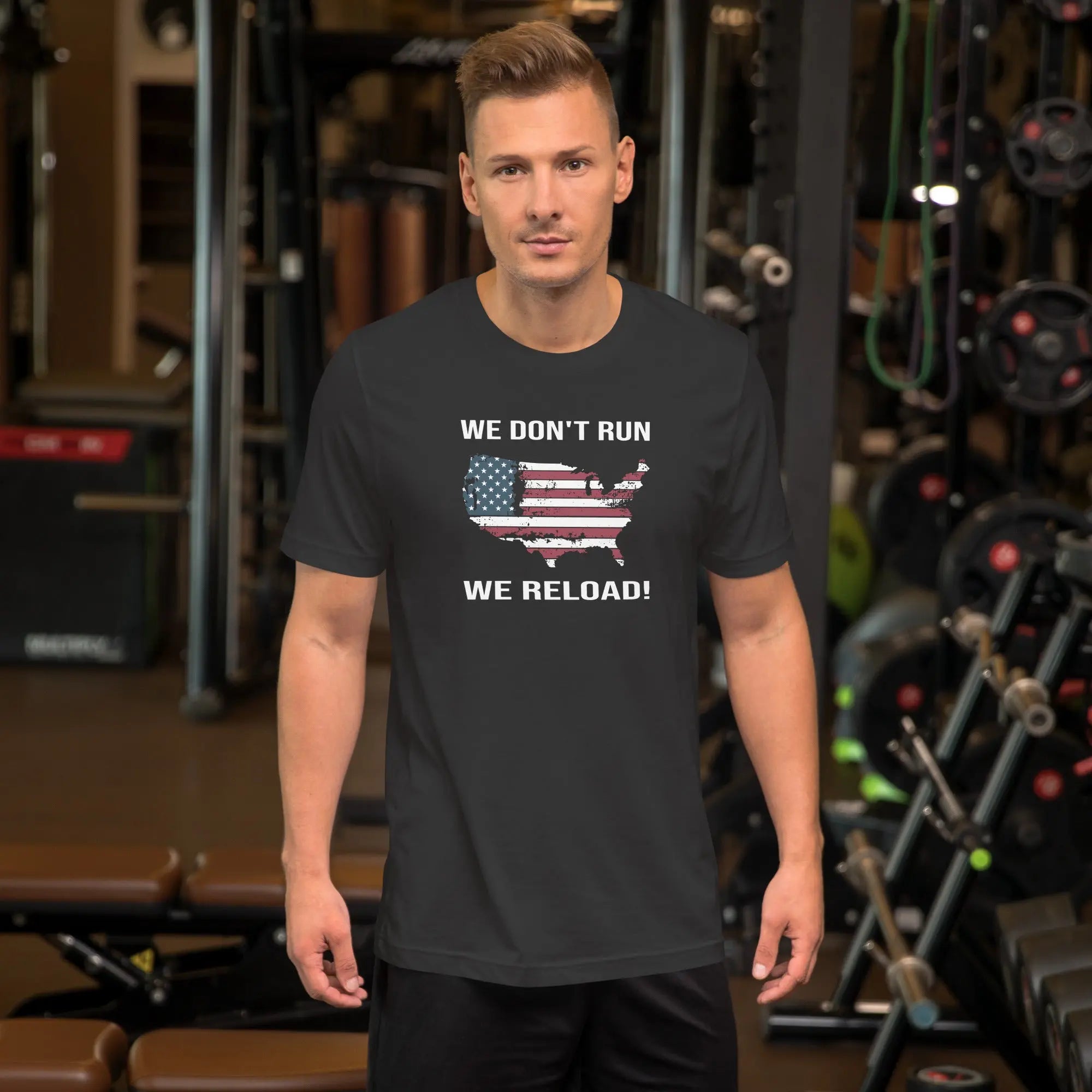 man wearing a flat black patriotic t-shirt with "We don't run, we reload" text.