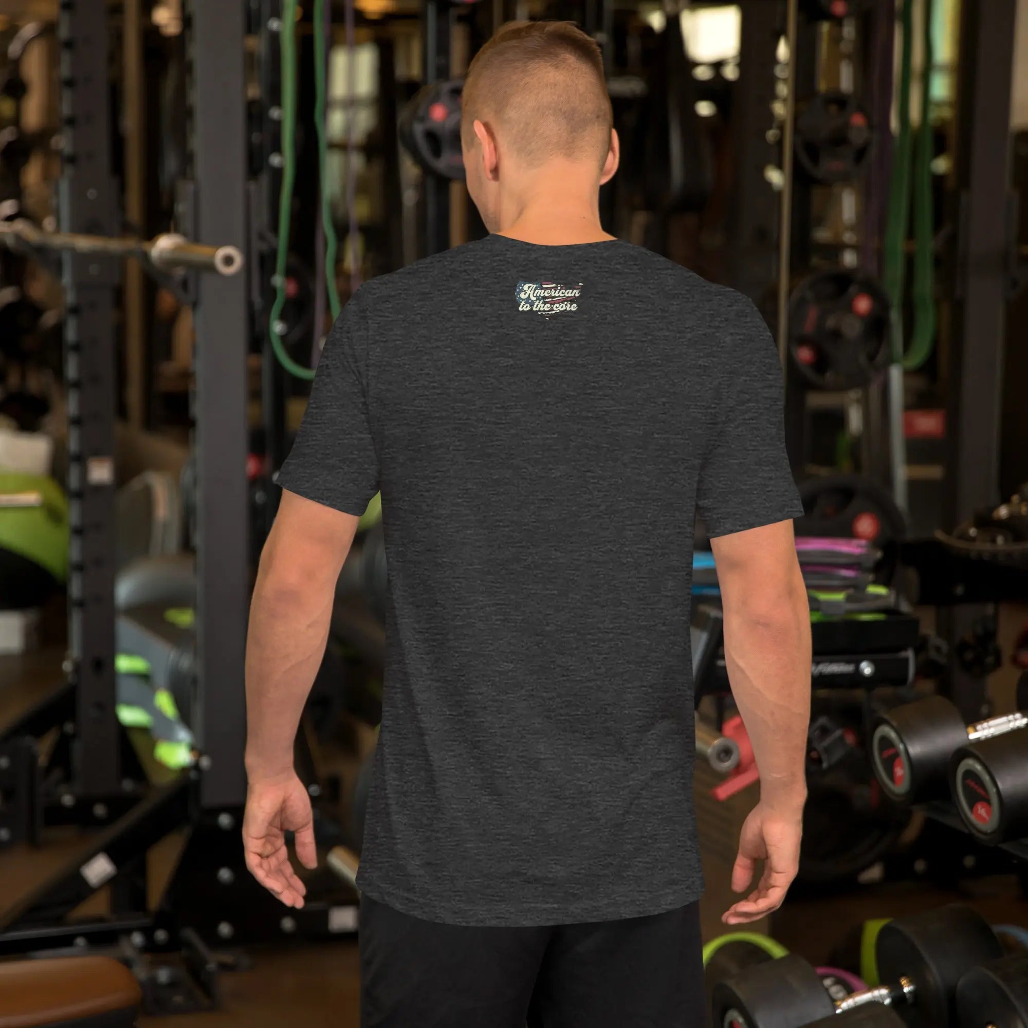Back of man wearing a dark grey patriotic t-shirt with "America to the core" text