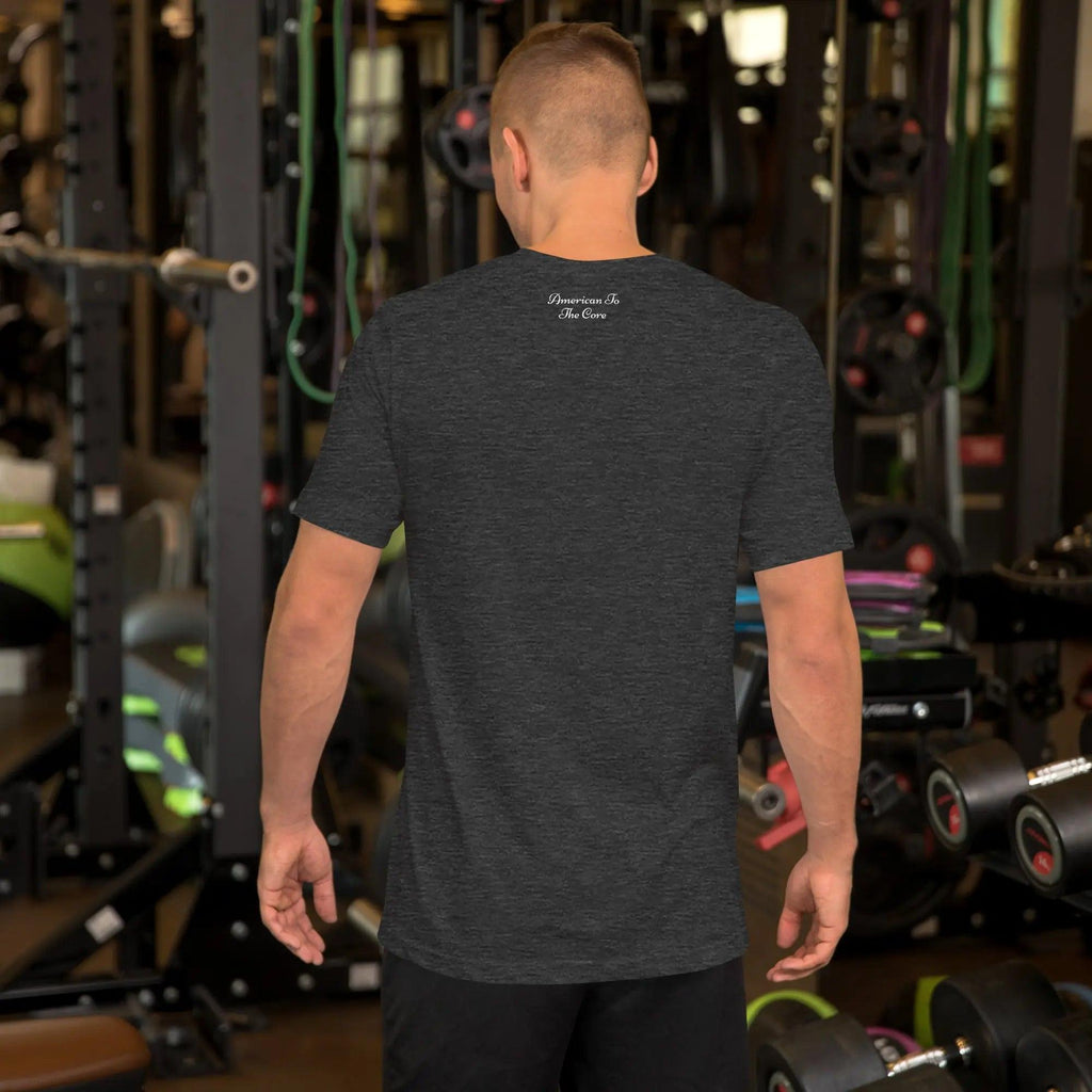 Back of a man wearing a dark grey heather patriotic t-shirt with the text "American To The Core."