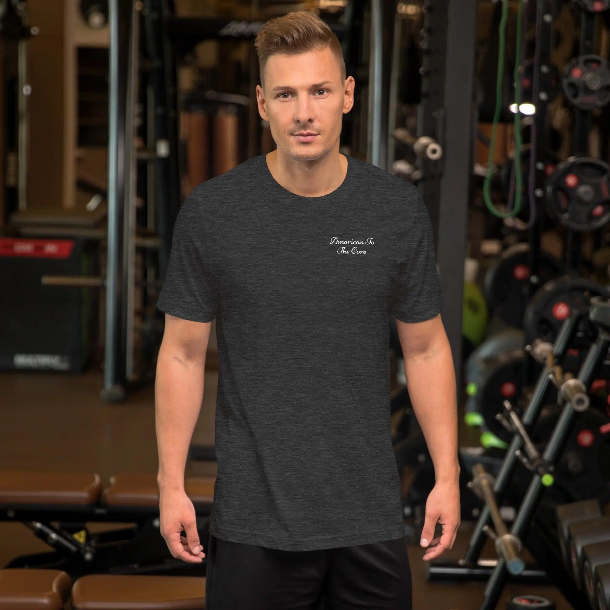 A man wearing a dark grey heather patriotic T-shirt with the text "American to the Core."