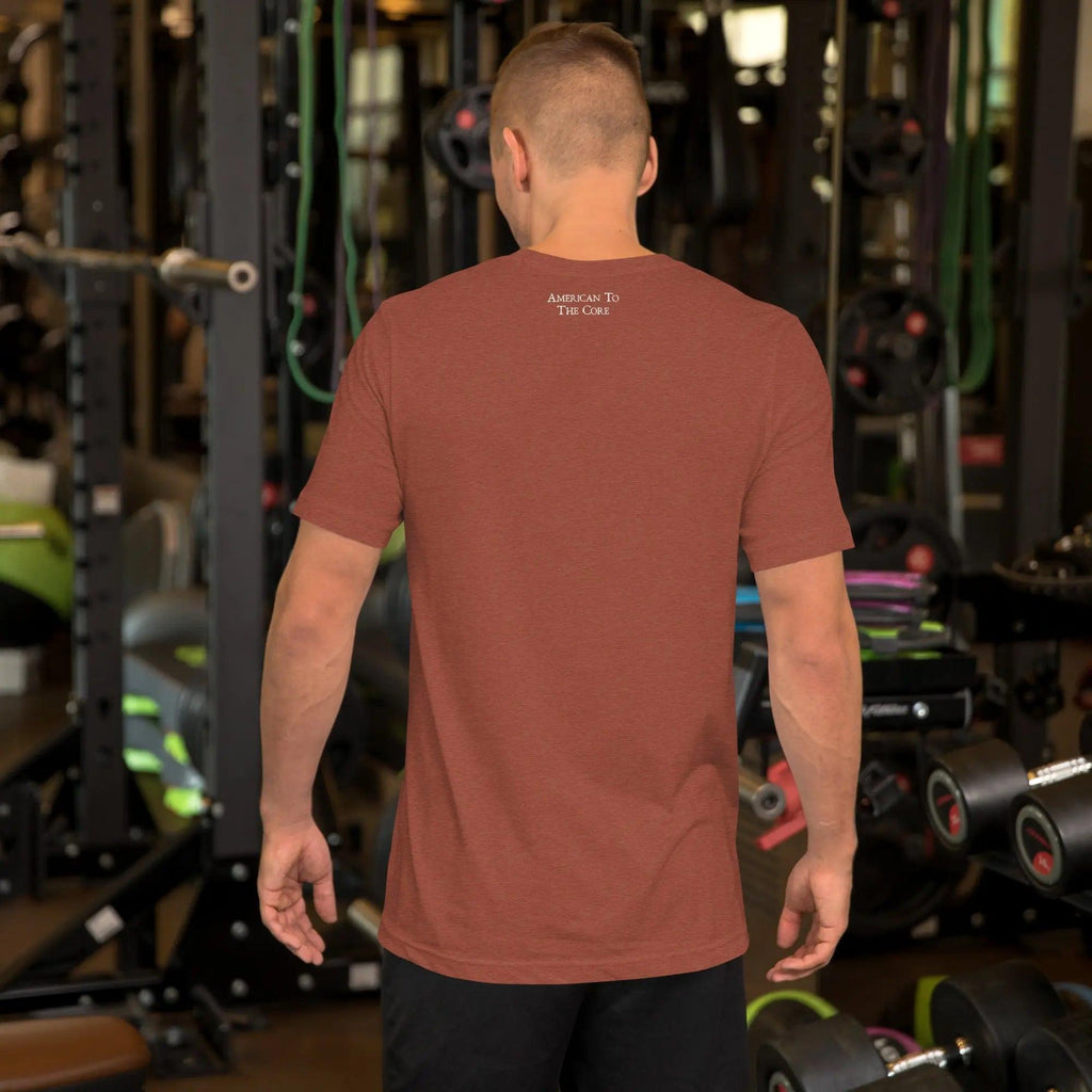 Back of a man wearing a clay heather patriotic t-shirt. With the text "American To The Core." 