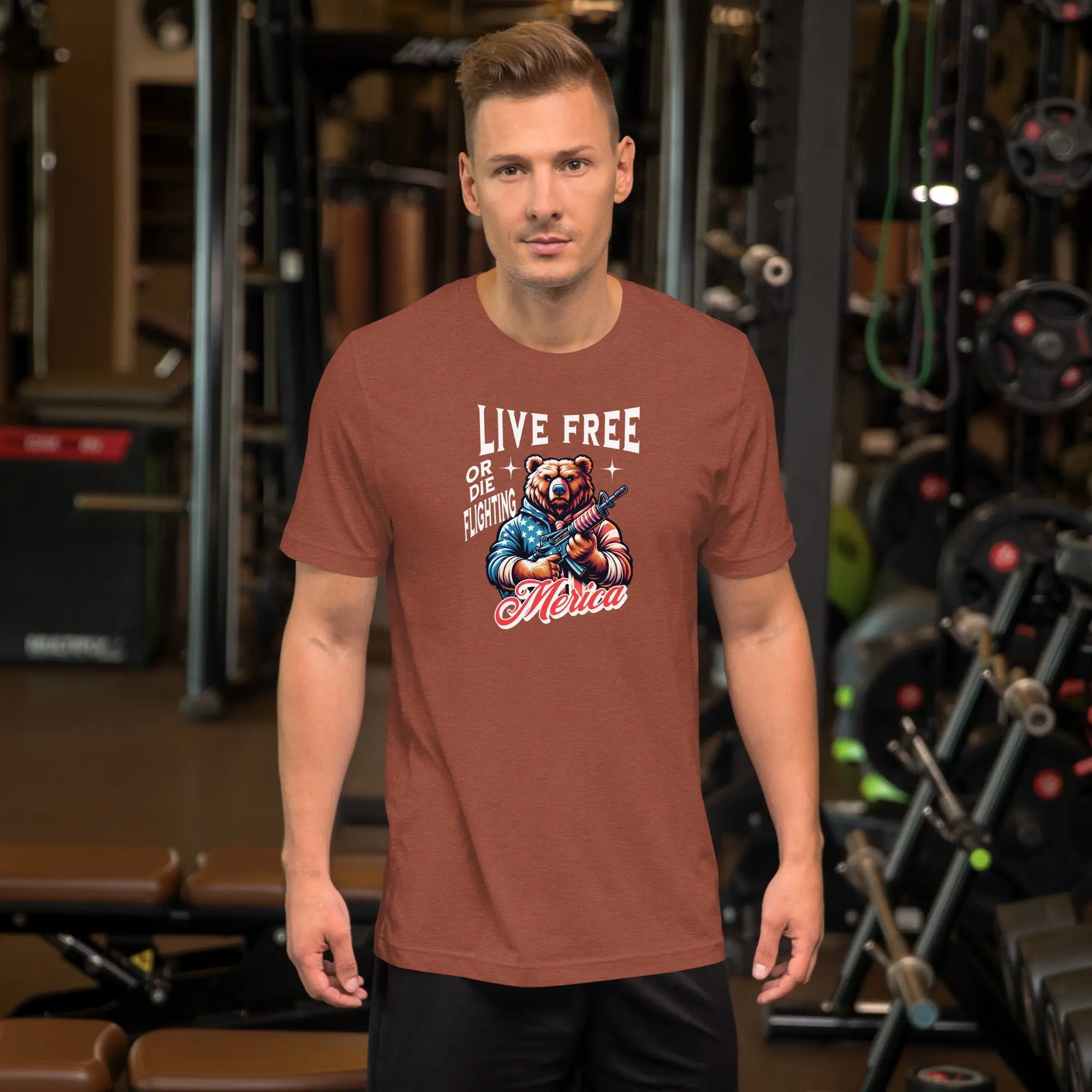 man wearing a heather clay patriotic t-shirt with a image of a bear holding a gun with "live free or die fighting Merica" text