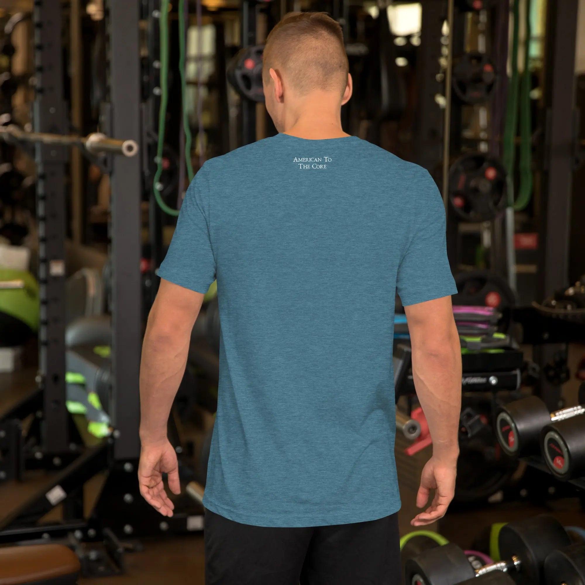 Back of a man wearing a heather deep teal patriotic t-shirt. With the text "American To The Core." 
