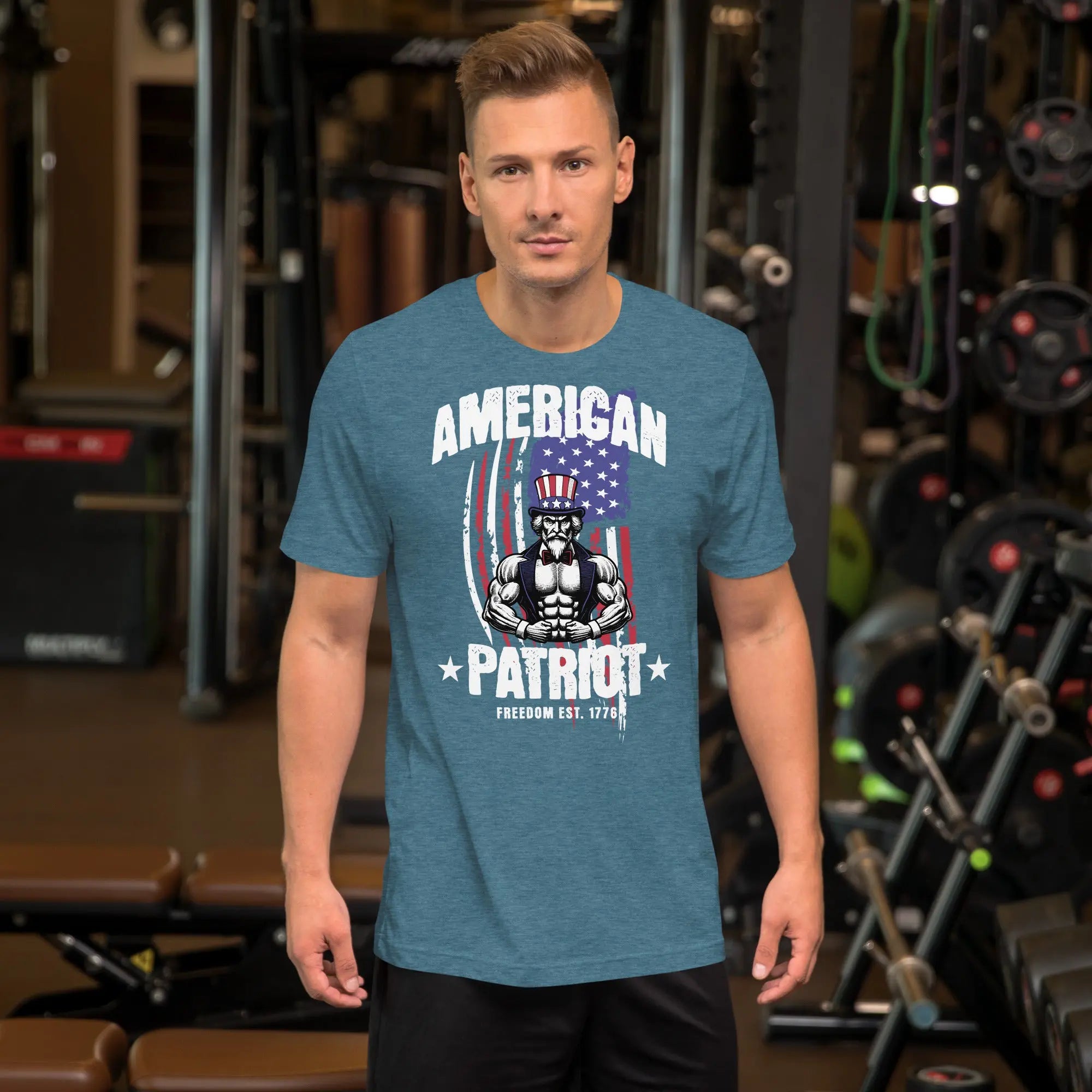 A man wearing a teal heather patriotic t-shirt with a muscular Uncle Sam with "American Patriot" text.