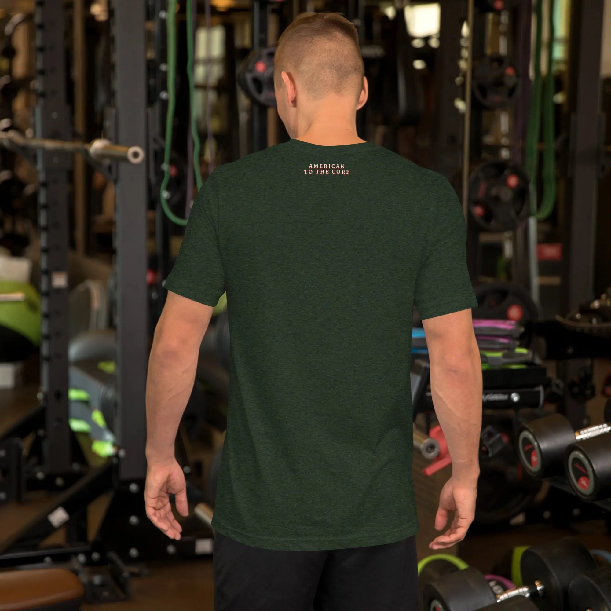 Back of man wearing a heather emerald patriotic t-shirt with "America to the core" text