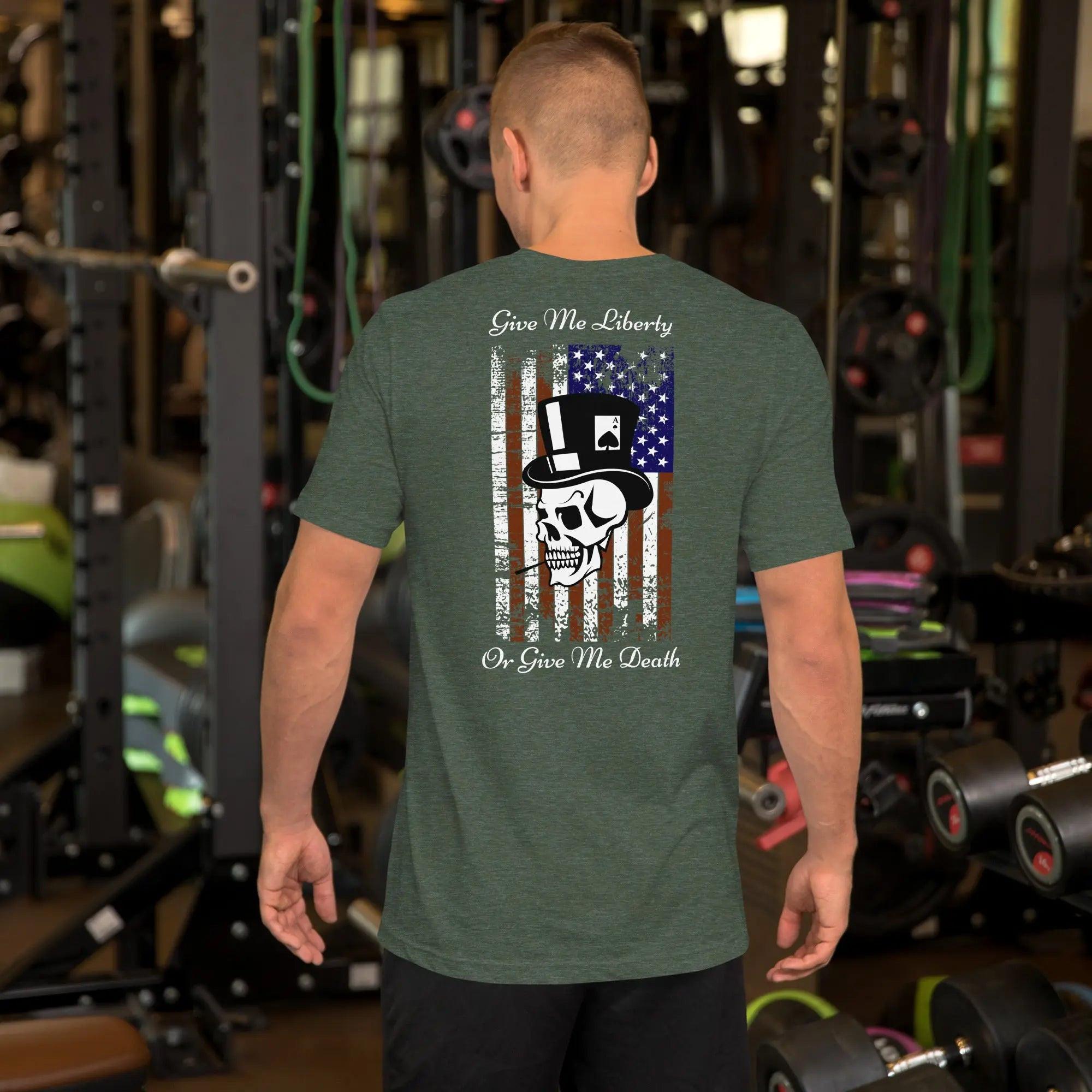 The back of a man wearing a heather forest patriotic T-shirt with a skull over the American flag and the text "Give Me Liberty or Give Me Death."