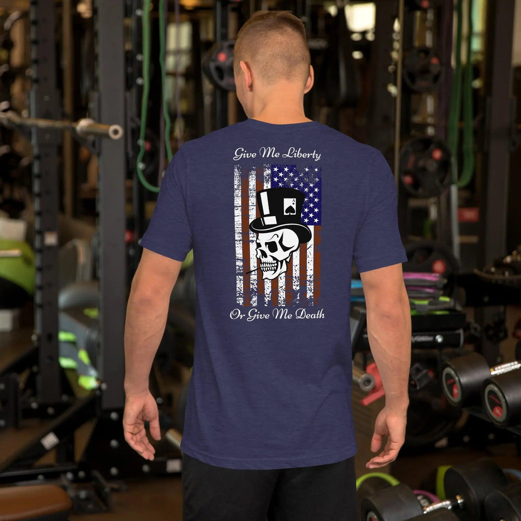 The back of a man wearing a heather midnight navy patriotic T-shirt with a skull over the American flag and the text "Give Me Liberty Or Give Me Death."