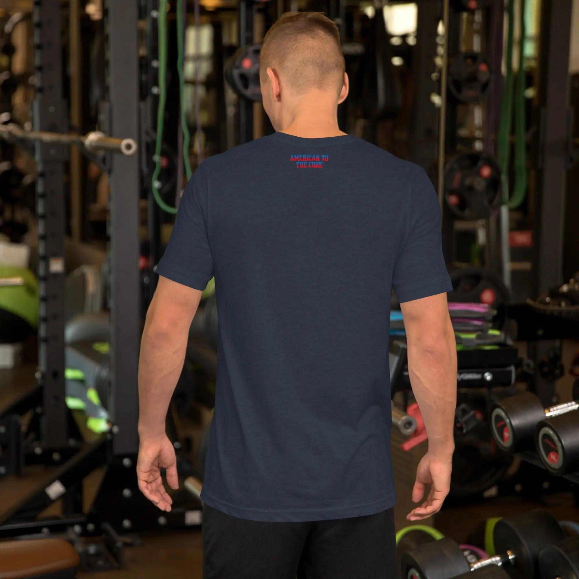 Back of a man wearing a navy-blue heather patriotic men's T-shirt with the text "American To The Core" in red and blue. 