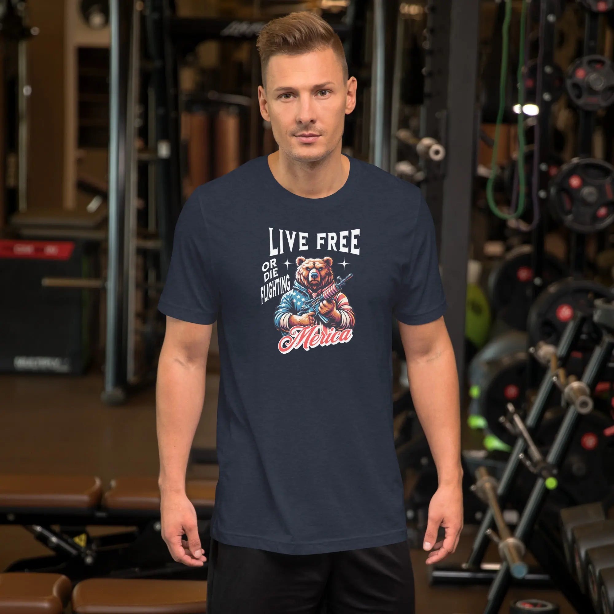 man wearing a navy heather patriotic t-shirt with a image of a bear holding a gun with "live free or die fighting Merica" text